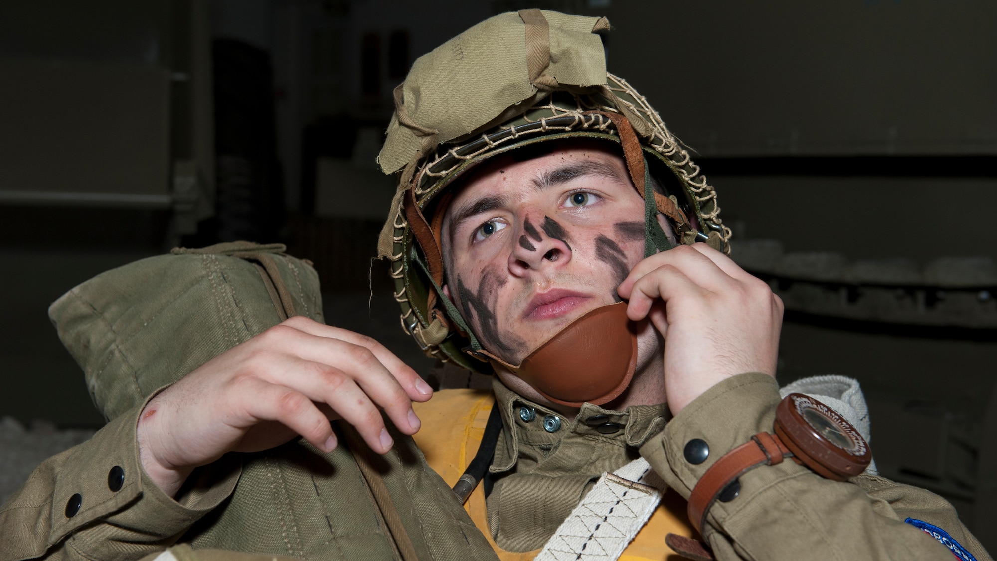 Christian Holland adjusts the chin strap of his combat helmet April 18, 2015, at the Air Mobility Command Museum on Dover Air Force Base, Del. Holland, 16, travelled from Hummelstown, Pa. to take part in the event. (U.S. Air Force photo/Airman 1st Class Zachary Cacicia)
