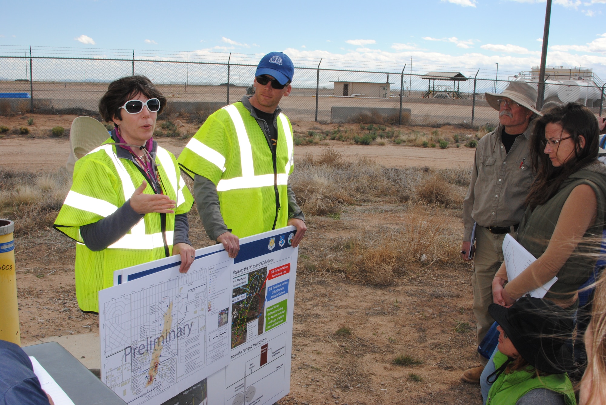 Lead scientist Dr. Adria Bodour (left), Air Force Civil Engineer Center, and Jason Tarbert, with environmental contractor CB&I, discuss migration of the contamination plume and recent positive results from monitoring wells with members of the public April 18 near Kirtland's Bulk Fuels Facility. The discussion took place as part of a field trip to give members of the community an in-depth look at the science behind remediation efforts. (Photo by Jim Fisher)
