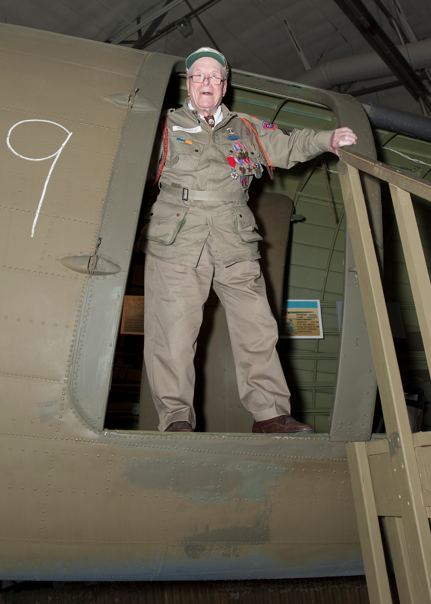 George Shenkle stands in the troop doorway of a C-47A Skytrain April 18, 2015, at the Air Mobility Command Museum near Dover Air Force Base, Del. Shenkle jumped out of this exact door on D-Day, June 6, 1944, over Sainte-Mère-Église, France. (U.S. Air Force photo/Airman 1st Class Zachary Cacicia) 