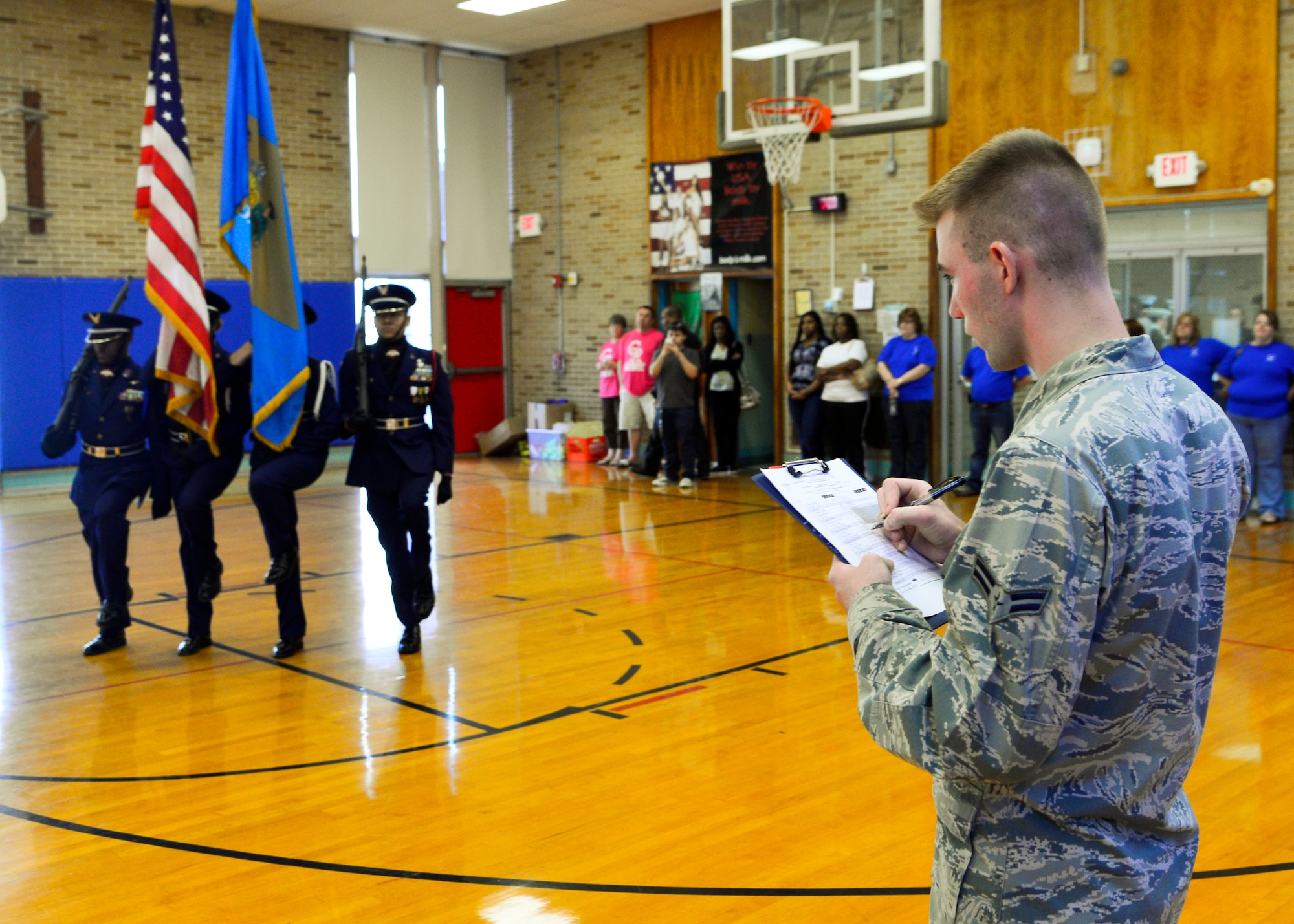 Airman 1st Class Gordon Wright, Dover Air Force Base Honor Guard, judges the William Penn High School Air Force Junior Reserve Officer Training Corps Color Guard team during the 2015 Eagle Classic Delaware State Military Drill Championship April 18, 2015, at Dover Air Force Base Middle School, Del. Color Guard routines were judged by members of the Air Force and Dover AFB Honor Guard. (U.S. Air Force photo/Airman 1st Class William Johnson)