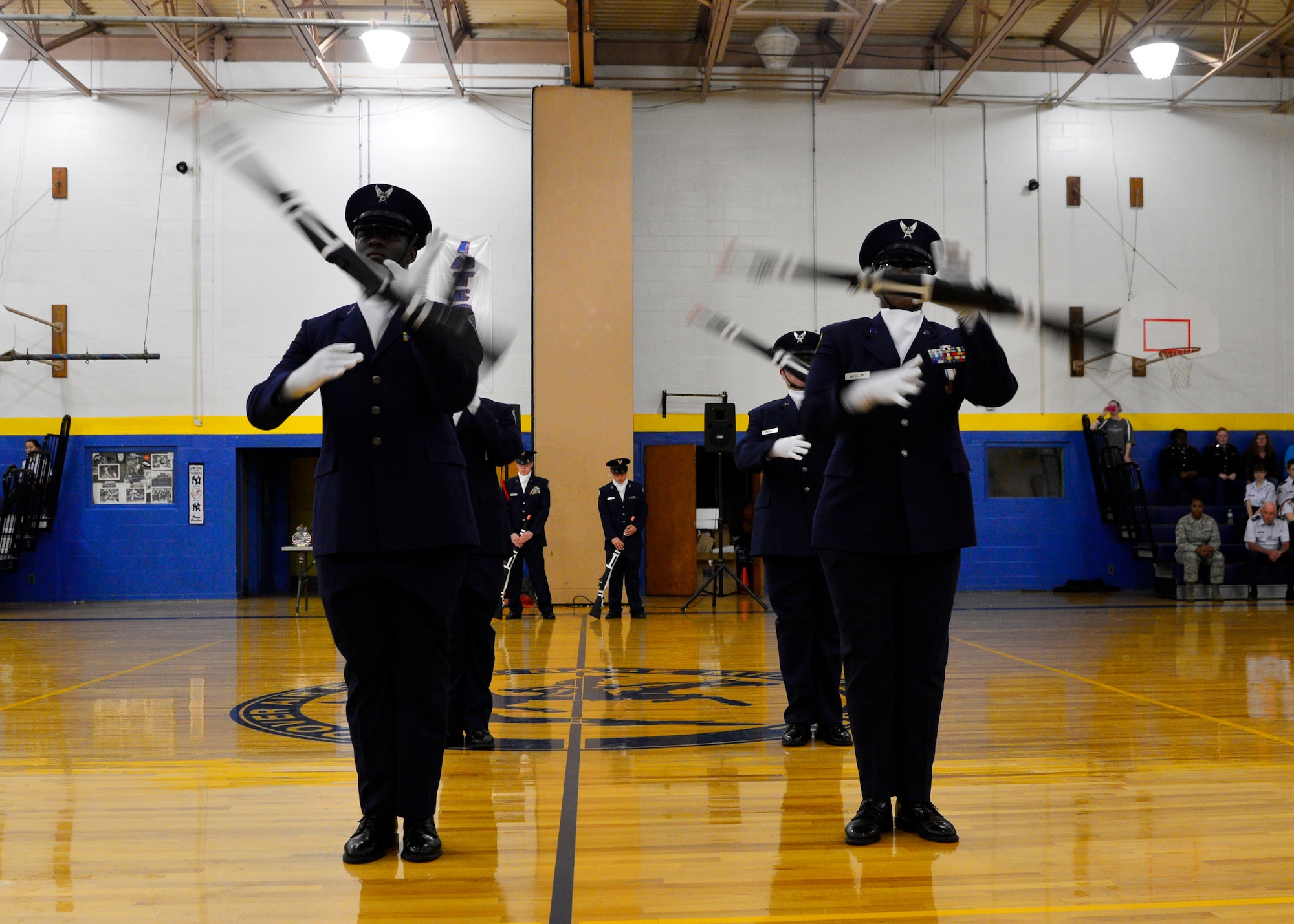 Members of the Smyrna High School Air Force Junior Reserve Officer Training Corps spin their Springfield M1903 rifles during the armed exhibition portion of the 2015 Eagle Classic Delaware State Military Drill Championship April 18, 2015, at Dover Air Force Base Middle School, Del. The armed exhibition routines are evaluated on creativity, difficulty and presentation of movements. (U.S. Air Force photo/Airman 1st Class William Johnson)