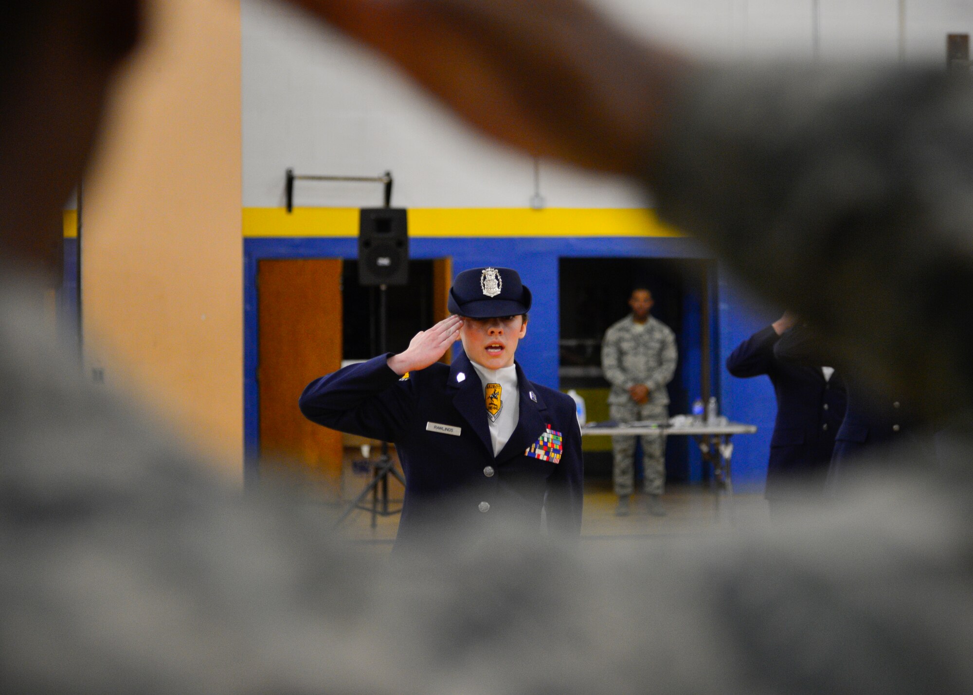 Cadet Capt. Alizabeth Rawlings, Caesar Rodney Air Force Junior Reserve Officer Training Corps, salutes and asks for permission to leave the drill grounds from Airman Quashawn Johnson, Air Force Honor Guard, during the 2015 Eagle Classic Delaware State Military Drill Championship April 18, 2015, at Dover Air Force Base Middle School, Del. The competition was judged by members of the Air Force and Dover AFB Honor Guard and was won by the Caesar Rodney AFJROTC program. (U.S. Air Force photo/Airman 1st Class William Johnson)