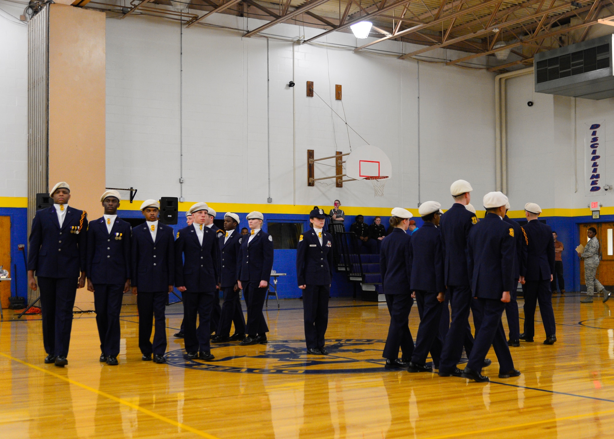 Cadet Capt. Alizabeth Rawlings, Caesar Rodney Air Force Junior Reserve Officer Training Corps, is circled by members of the drill team during the unarmed exhibition event of the 2015 Eagle Classic Delaware State Military Drill Championship April 18, 2015, at Dover Air Force Base Middle School, Del. Caesar Rodney beat out seven other JROTC programs from the state of Delaware to win first place in the event. (U.S. Air Force photo/Airman 1st Class William Johnson)