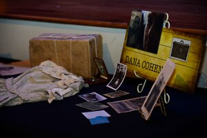 Memorabilia representing the life of Dana Cohen are displayed during a Holocaust Remembrance Ceremony at Fort Eustis, Va., April 17, 2015. Cohen and her mother were taken from their home in Poland to work as slave laborers in Siberia, for one piece of bread a day. (U.S. Air Force photo by Senior Airman Kimberly Nagle/Released) 