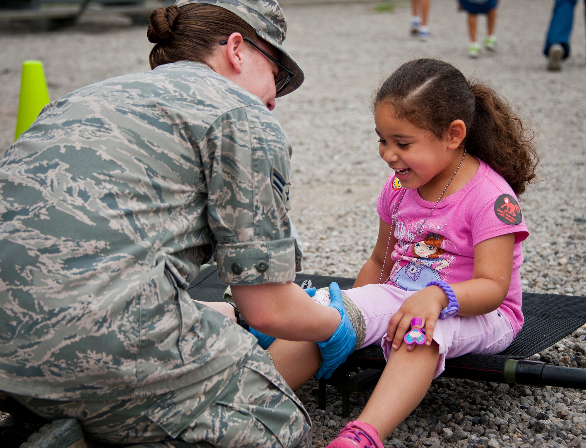 An 96th Medical Group Airman wraps the leg of a young deployer during a medical demonstration for Operation Hero April 18 at Eglin Air Force Base, Fla. More than 275 kids participated in this year’s event which is a mock deployment experience created to give military children a glimpse of what their loved ones go through when they leave home. The kids went through a deployment line to get their dog tags and “immunizations” before they were briefed by the commander and shipped off to a deployed location. There, they participated in various activities and demonstrations put on by local base agencies. (U.S. Air Force photo/Sara Vidoni)