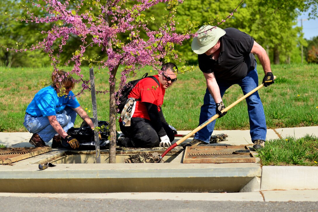 Members of Joint Base Langley-Eustis clean out a storm drain at Fort Eustis, Va., April 21, 2015. The team cleaned several storm drains on the installation and installed a water filtering system as a part of Earth Week. Cleaning the drains and installing the new system will clean the water that flows into local Virginia waterways. (U.S. Air Force photo by Staff Sgt. Natasha Stannard/Released)