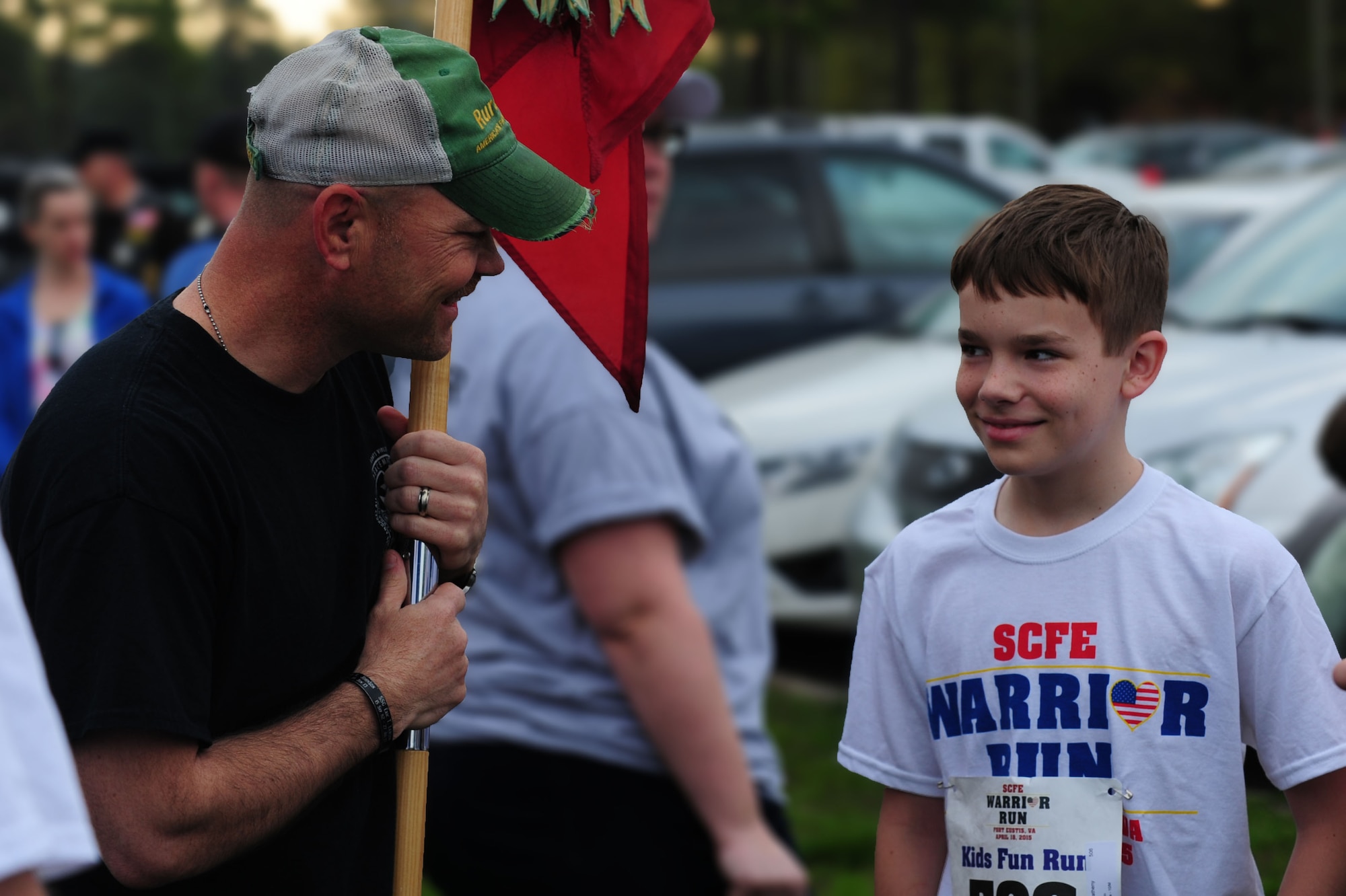 U.S. Army Staff Sgt. Rodney Golden, race participant from the 359th Inland Cargo Transfer Company, 10th Transportation Battalion, 7th Transportation Brigade (Expeditionary), left, speaks with Derrik Nouv at the Warrior Run at Fort Eustis, Va., April 18, 2015. The Spouse’s Club of Fort Eustis hosted the Warrior Run in an effort to support Wounded Warriors and their families. The 359th ICTC ran with Nouv and his sister in honor of the children’s mother who was killed-in-action in 2013. (U.S. Air Force photo by Staff Sgt. Natasha Stannard/Released) 