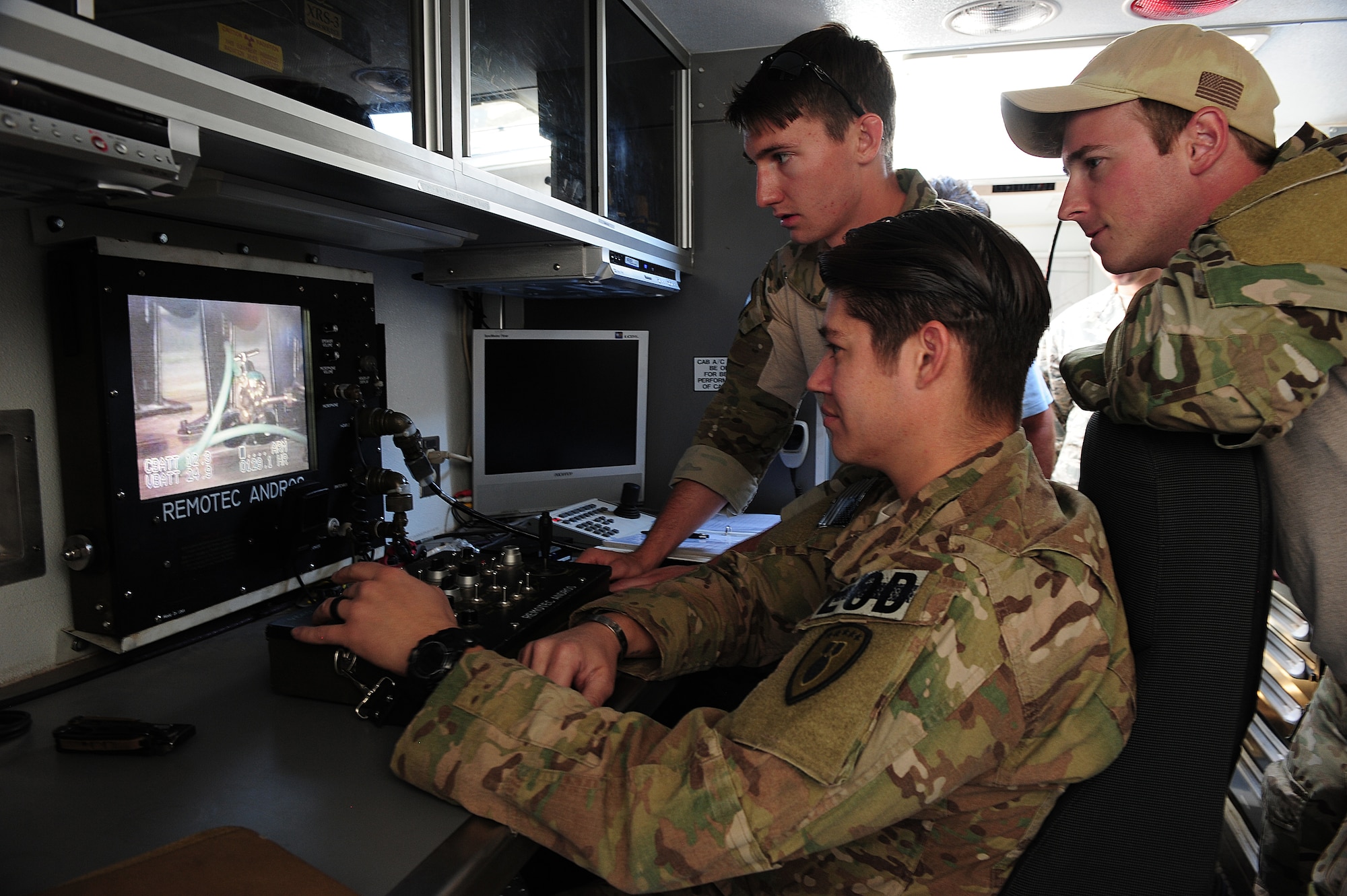 Members of the 355th Civil Engineering Squadron's Explosive Ordnance Disposal flight, operate an ANDROS F6A robot during a weapons of mass destruction training exercise inside the base theater at Davis-Monthan Air Force Base, Ariz., April 8, 2015. The EOD members' objective during the exercise was to locate and assess the threat and disable the potentially destructive device. (U.S. Air Force photo by Airman 1st Class Chris Drzazgowski/Released)