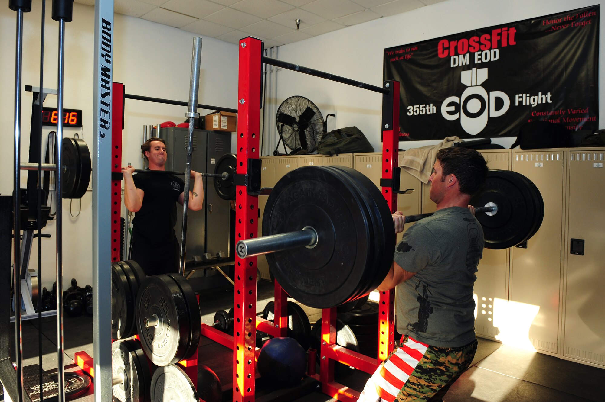 U.S. Air Force Tech. Sgt. Jason Ostberg and Staff Sgt. Nicholas Jensen, 355th Civil Engineering Squadron Explosive Ordnance Disposal technicians, perform barbell shoulder presses at Davis-Monthan Air Force Base, Ariz., April 8, 2015. EOD technicians are required to engage in physical training five days per week to maintain individual strength, stamina, and aerobic capacity at a level appropriate for the EOD mission. (U.S. Air Force photo by Airman 1st Class Chris Drzazgowski/Released) 