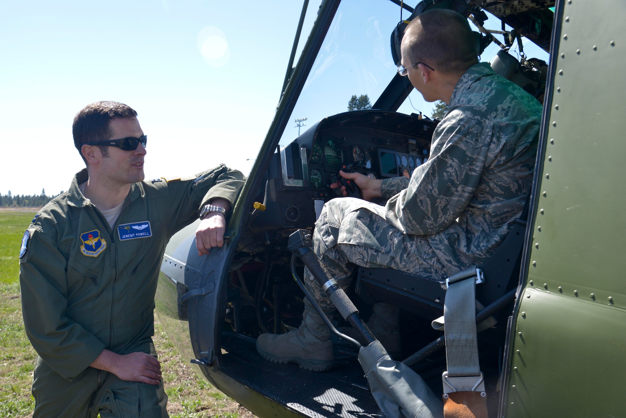 Capt. Jeremy Powell, 336th Training Group executive officer, explains how the UH-1N Iroquois helicopter works to a Central Washington University Air Force ROTC student during a base wide tour April 17, 2015, at Fairchild Air Force Base, Wash. Students from CWU came to Fairchild to receive a tour and learn more about what the Air Force has to offer. (U.S. Air Force photo/Senior Airman Janelle Patiño)