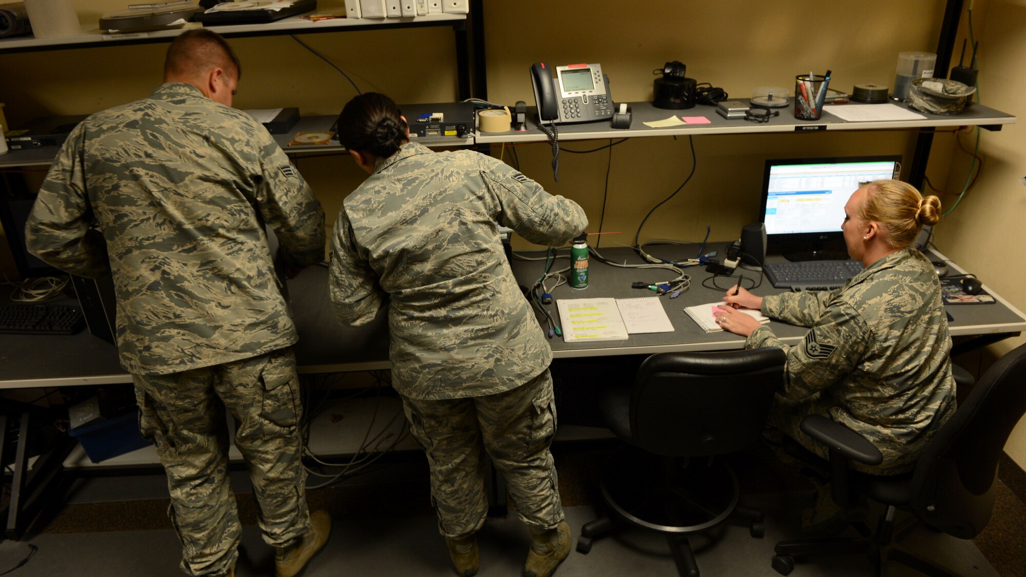 U.S. Air Force Airmen assigned to the 20th Communication Squadron fix computers at Shaw Air Force Base, S.C., April 14, 2015. The 20th Fighter Wing is holding a cyber-security week, April 27 through May 1 to help better the cyber security knowledge of Airmen. (U.S. Air Force photo by Senior Airman Jensen Stidham/Released)
