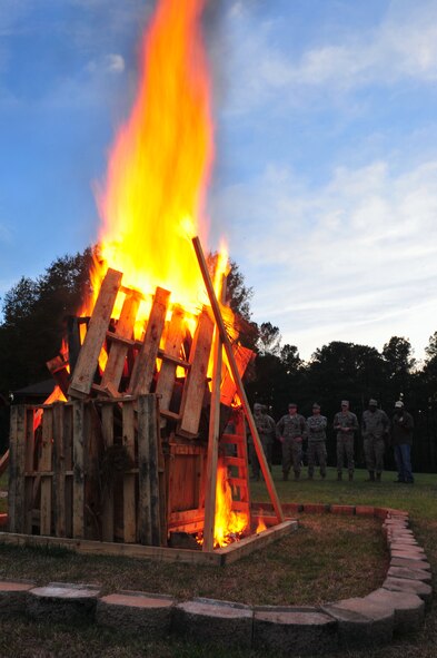 Members of the 4th Fighter Wing gather during the Sexual Assault Prevention and Response bonfire, April 11, 2015, at Seymour Johnson Air Force Base, North Carolina. During the month of April, the Department of Defense joined the national observance of Sexual Assault Awareness Month to raise awareness and promote the prevention of sexual violence. (U.S. Air Force photo by Senior Airman John Nieves Camacho)