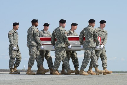 A U.S. Army carry team transfers the remains of Jewel W. Everett, a Dept. of Defense civilian during a dignified transfer ceremony, April 21, 2015, Dover Air Force Base, Del. Everett was assigned to Headquarters and Headquarters Company, Area Support Group-Kuwait, Camp Arifjan, Kuwait. (U.S. Air Force photo/Greg L. Davis)