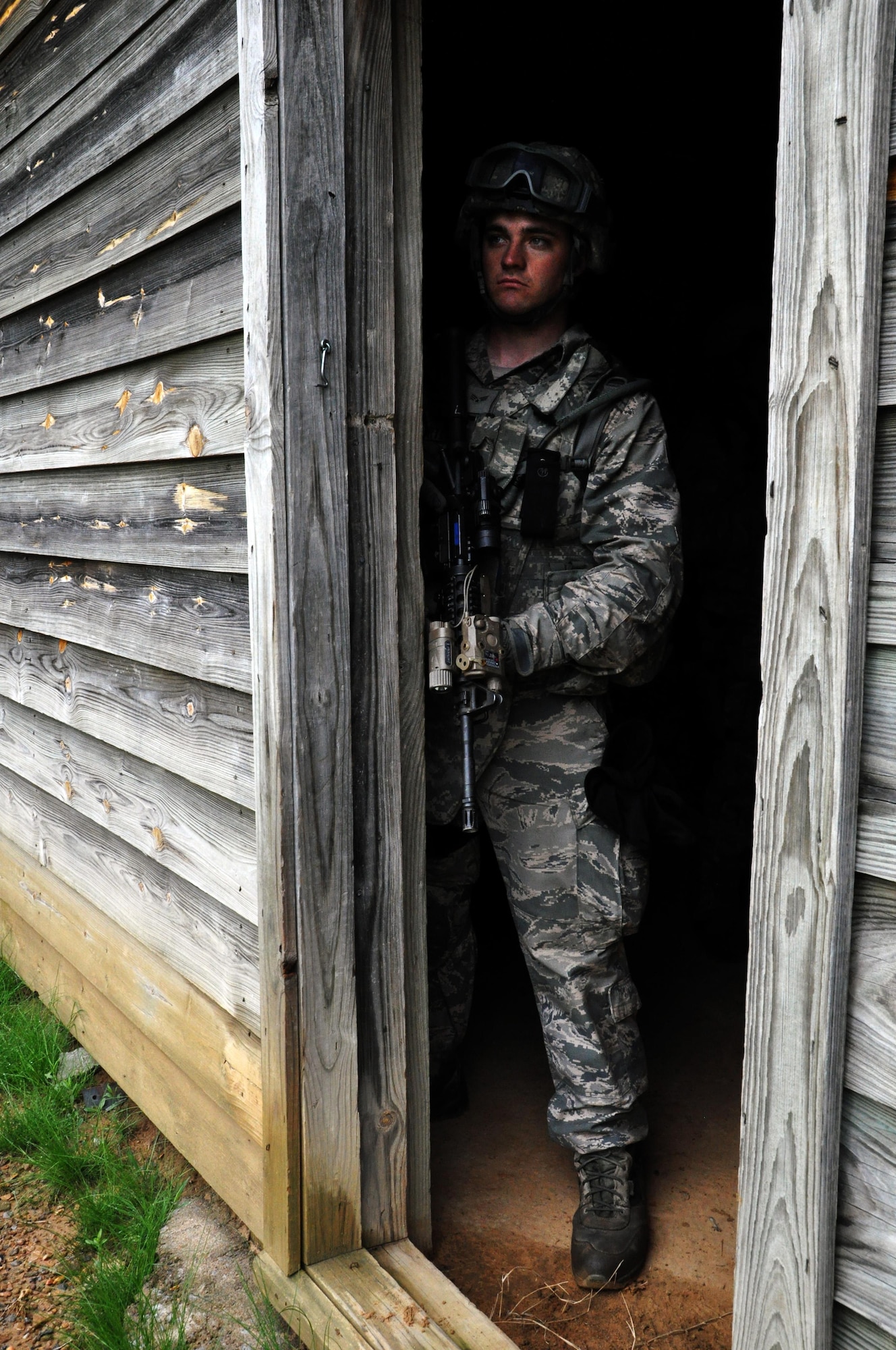 Senior Airman Samuel Sortet, 931st Security Forces Squadron, provides security during a  military operations on urban terrain (MOUT) training exercise at Camp Gruber Training Center, Okla., April 15, 2015.  More than 80 members of the 931 SFS and 931st Civil Engineer Squadron participated in ten days of combat skills training at Camp Gruber, which included land navigation, weapons training, tactical movements, convoy operations, base defense, room clearing procedures, foot patrols, military operations on urban terrain (MOUT) and combat lifesaving.  (U.S. Air Force photo by Capt. Zach Anderson)
