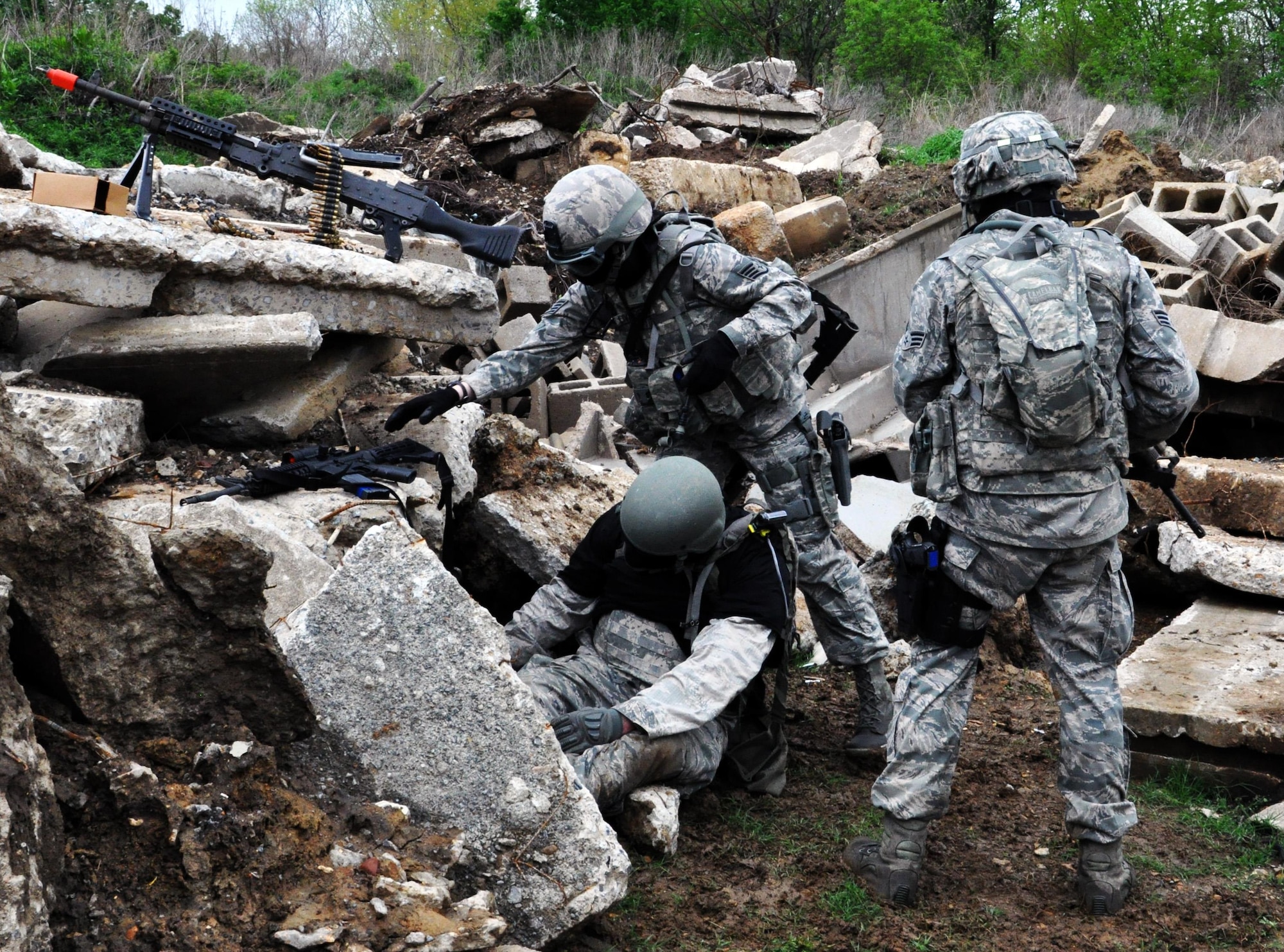 Members of the 931st Security Forces Squadron and 931st Civil Engineer Squadron search an "enemy" for intelligence information following a simulated firefight during a foot patrol training exercise at Camp Gruber Training Center, Okla., April 15, 2015.  The "enemy" was an Airman playing the role of an opposing force for the purposes of the training.  More than 80 members of the two squadrons participated in ten days of combat skills training at Camp Gruber, which included land navigation, weapons training, tactical movements, convoy operations, base defense, room clearing procedures, foot patrols, military operations on urban terrain (MOUT) and combat lifesaving.  (U.S. Air Force photo by Capt. Zach Anderson)
