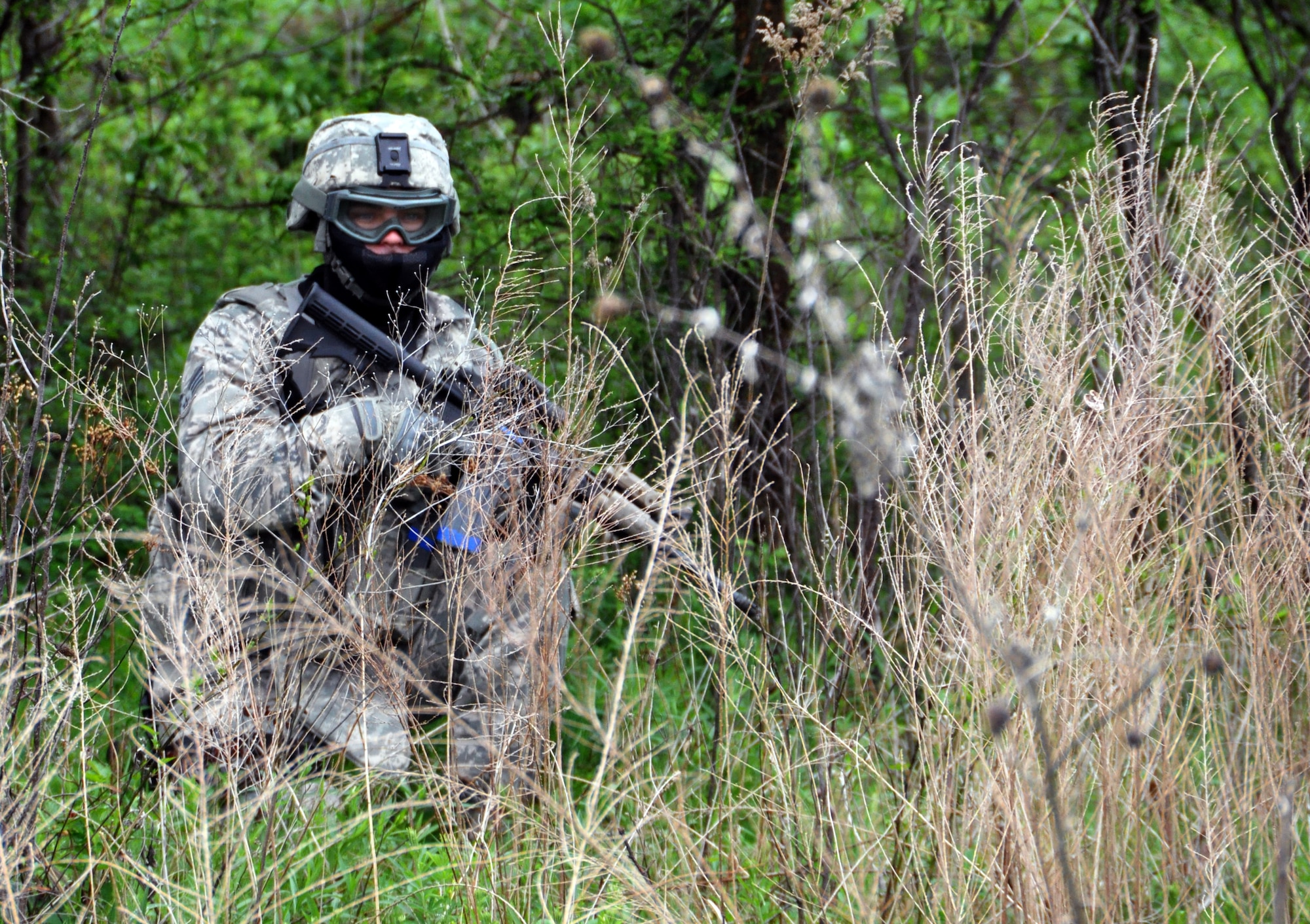 A member of the 931st Security Forces Squadron provides security during a foot patrol exercise at Camp Gruber Training Center, Okla., April 15, 2015.  More than 80 members of the 931 SFS and 931st Civil Engineer Squadron participated in ten days of combat skills training at Camp Gruber, which included land navigation, weapons training, tactical movements, convoy operations, base defense, room clearing procedures, foot patrols, military operations on urban terrain (MOUT) and combat lifesaving.  (U.S. Air Force photo by Capt. Zach Anderson)
