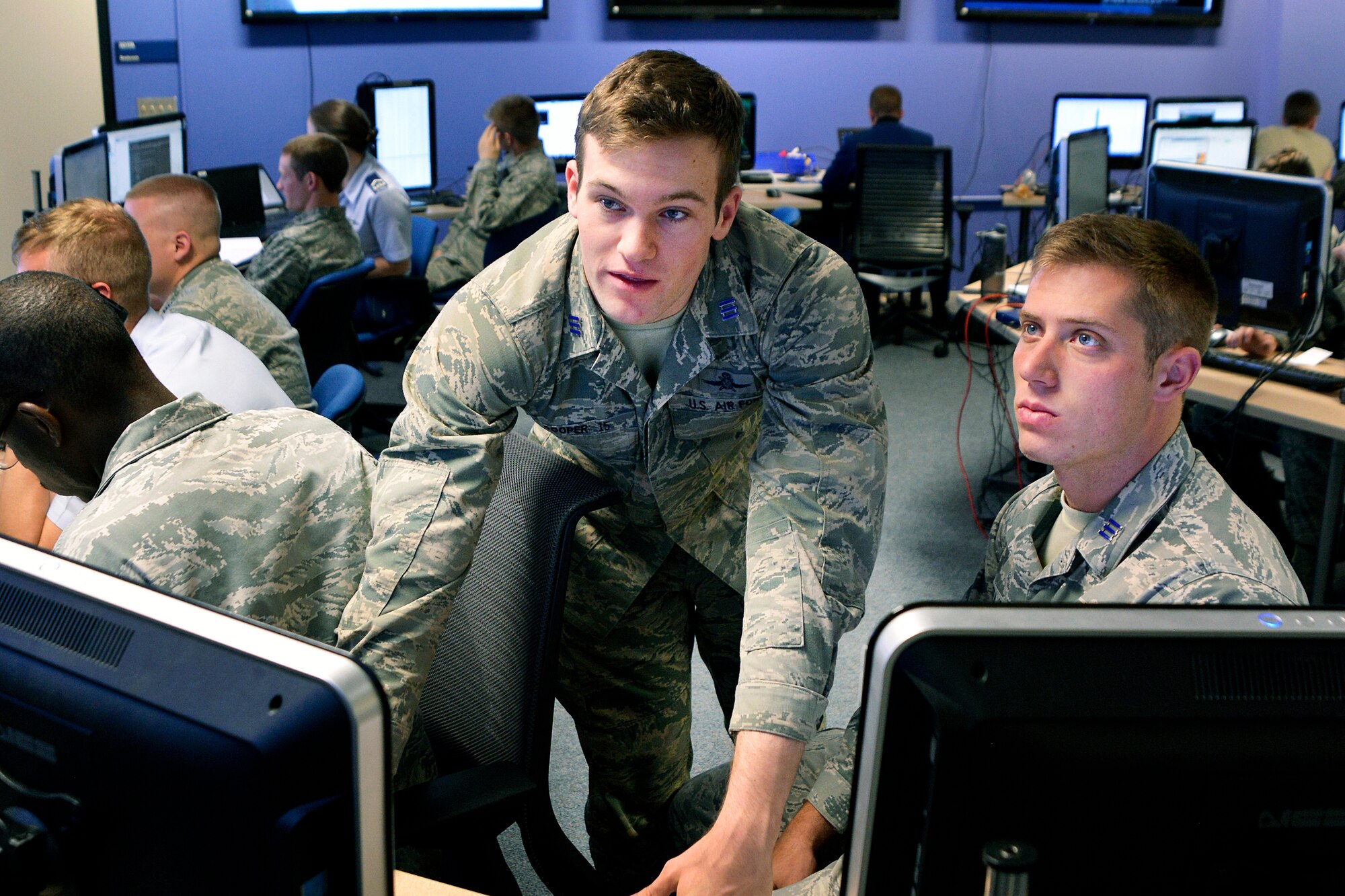 Cadet 1st class Kevin Cooper, captain of the Academy Cyber Team, puzzles over a problem during the the National Security Administration's 15th annual Cyber Defense Exercise April 13, 2015. The Academy team finished second. (U.S. Air Force photo/Jason Gutierrez)
