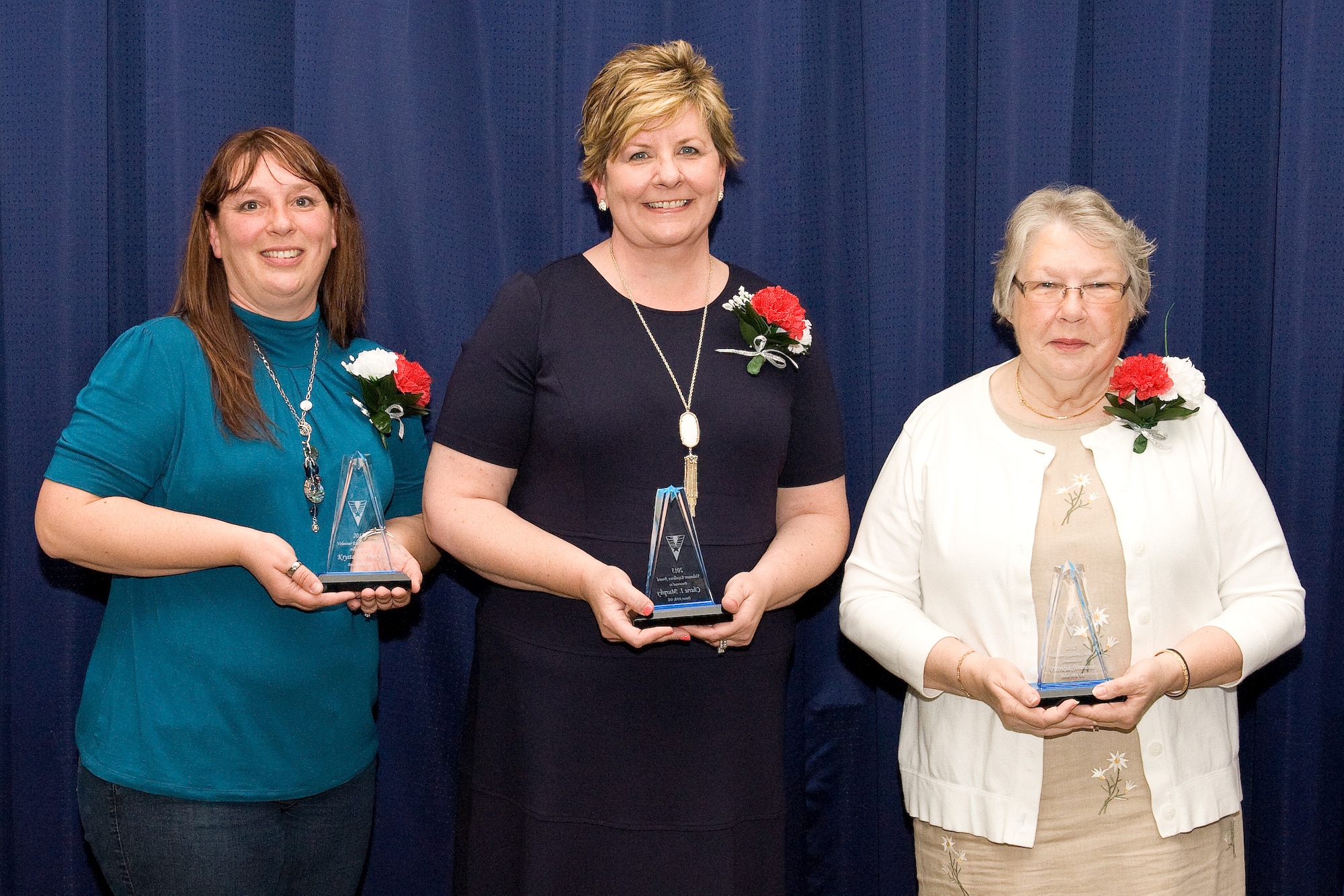 Ten Team Dover volunteers were recognized during the 2015 Volunteer Excellence Awards ceremony April 17, 2015, at The Landings on Dover Air Force Base, Del. The Category I, Federal Civilian Volunteer Excellence Award winner was Mrs. Krystal Henry, 436th Communication Squadron, left; the Category II, Family Member Volunteer Excellence Award winner was Mrs. Cherie Murphy, wife of Col. Kevin Murphy, 436th Medical Group commander, center; and the Category III, Military Retiree Volunteer Excellence Award winner was Mrs. Patricia Simmons, right. (U.S. Air Force photo/Roland Balik)