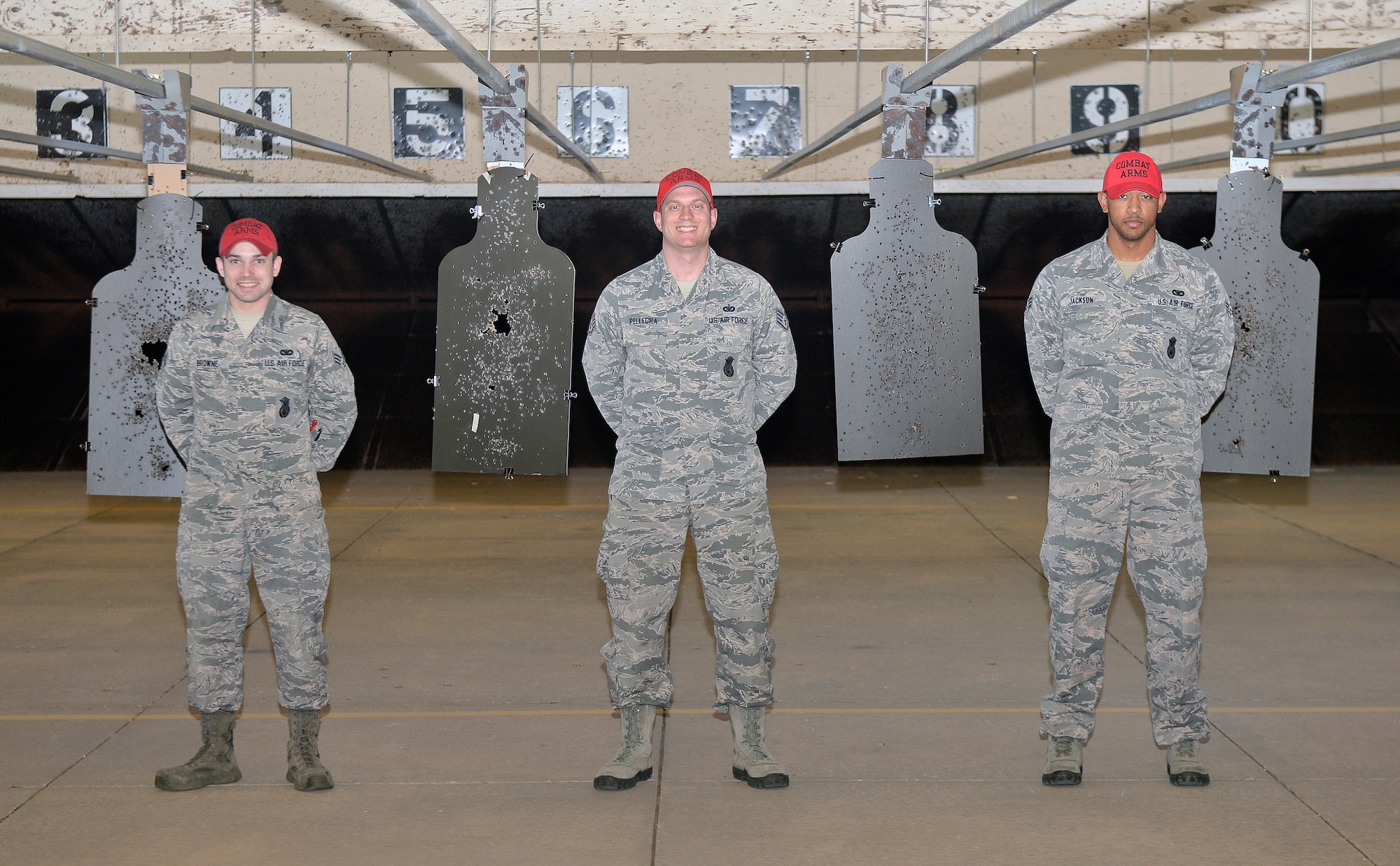 The members of the combat arms team pose for a photo April 1, 2015, at McConnell Air Force Base, Kan. The CATM instructors teach the proper way to disassemble, reassemble, shoot and clean weapons as a part of the training course class. (U.S. Air Force photo by Senior Airman Colby L. Hardin)