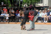 Nancy Rogers(right), Breeding Program Foster volunteer, and Jjared, a military working dog in training from the MWD program, demonstrate the unique capabilities and vital mission of military working dogs April 20 during the Air Force at the Alamo events in conjunction with Fiesta San Antonio.  Fiesta San Antonio, the city's 11-day historical celebration, began as a one-time parade in 1891 to honor the memory of the heroes of the Alamo and the Battle of San Jacinto. Over the past century, Fiesta has grown into a celebration of San Antonio's rich and diverse cultures. Military representative from throughout San Antonio participate each year in receptions, parades, pilgrimages and memorials. (U.S. Air Force photo by Melissa Peterson/released)