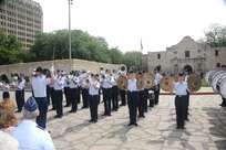 The Joint Base San Antonio-Lackland Drum and Bugle Corps, comprised of Air Force basic military trainees who have been in the Air Force less than seven weeks, perform during Air Force at the Alamo during Fiesta San Antonio April 20. From its beginning in 1891, Fiesta has grown into an annual celebration that includes civic and military observances, street and river float parades, exhibits, sports, music and food representing the spirit, diversity and vitality of San Antonio. (U.S. Air Force photo by Melissa Peterson/released)