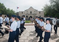 The Joint Base San Antonio-Lackland Drum and Bugle Corps, comprised of Air Force basic military trainees who have been in the Air Force less than seven weeks, perform during Air Force at the Alamo during Fiesta San Antonio April 20. From its beginning in 1891, Fiesta has grown into an annual celebration that includes civic and military observances, street and river float parades, exhibits, sports, music and food representing the spirit, diversity and vitality of San Antonio. (U.S. Air Force photo by Melissa Peterson/released)