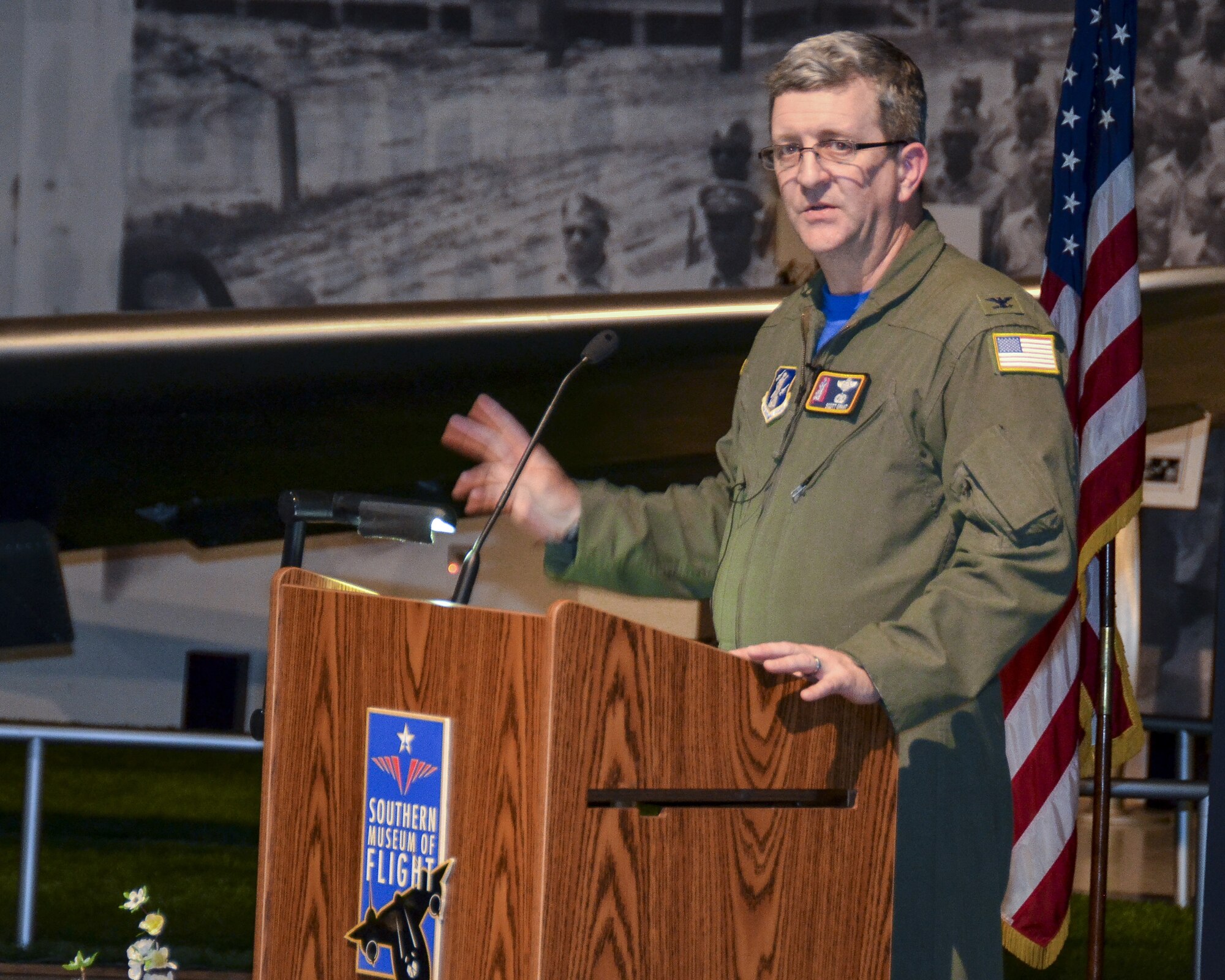 Col. Scott Grant the 117th Air Refueling Wing Vice Commander speaks at the Southern Museum of Flight during a reception held to honor survivors and family members of the Bay of Pigs invasion in Cuba.(U.S. Air National Guard photo by: Senior Master Sgt. Ken Johnson/Released)