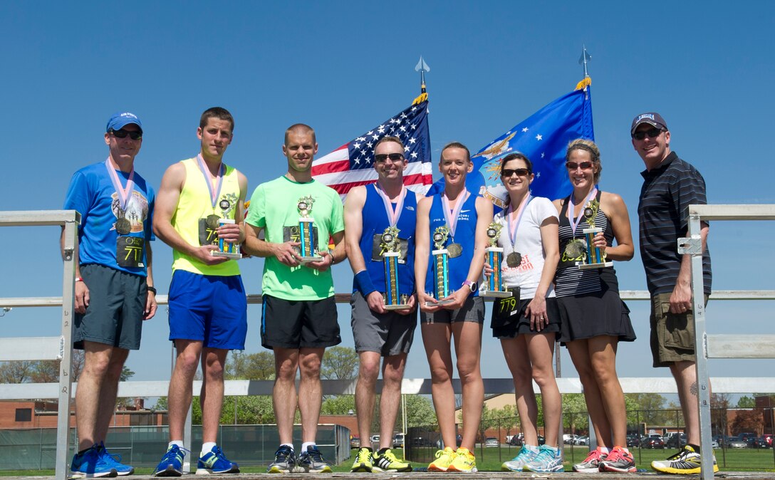 Col. Brad Hoagland, 11th Wing commander, and Chief Master Sgt. Vance Kondon, 11th Wing command chief, have their photo taken with the men and women who placed at the Joint Base Andrews Half-Marathon, April 18, 2015, at Joint Base Andrews, Maryland. This was the third annual half-marathon held at JBA and the race had approximately 150 participants. (U.S. Air Force photo/Senior Airman Mariah Haddenham)