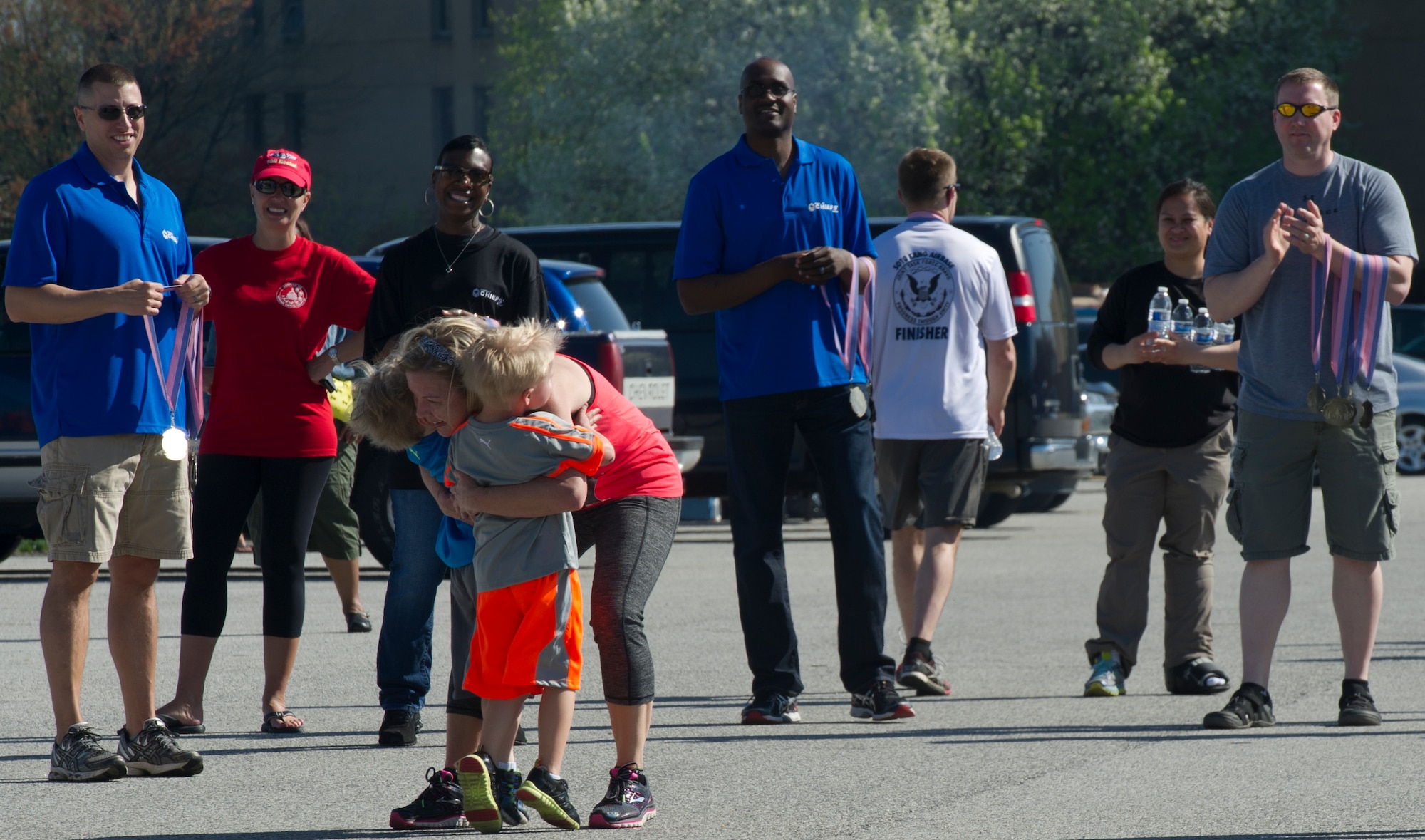 Capt. Laura Ivey-Glines, 779th Air Medical Squadron clinical nurse, embraces her sons as they meet her at the finish line at the Joint Base Andrews Half-Marathon, here, April 18, 2015. The race coincided with the Amazing Base Family Fest that included entertainment, family activities and food. (U.S. Air Force photo/Senior Airman Mariah Haddenham)