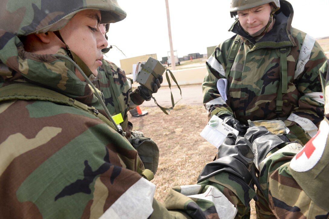 Airman 1st Class Oscar Ruiz-Camacho, 28th Medical Operation Squadron bioenvironmental technician, uses a 256 kit to test air quality after a simulated chemical attack during an operational readiness exercise at Camp Lancer on Ellsworth Air Force Base, S.D., March 30, 2015. During the exercise, bioenvironmental technicians used 256 kits to simulate testing the air for chemical agents and to identify any present chemicals. (U.S. Air Force photo by Airman 1st Class Rebecca Imwalle/ Released) 