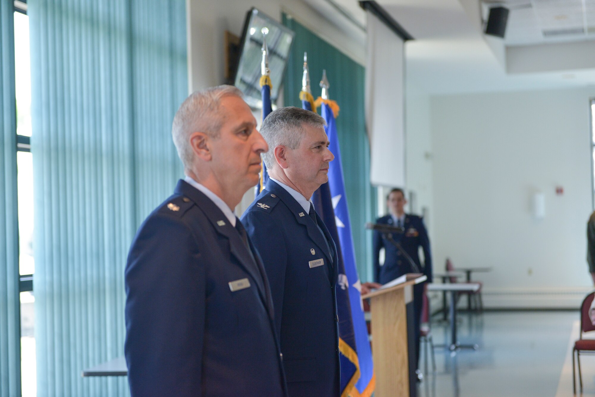 Lt. Col. Alan Ross (left), 109th Airlift Wing vice commander, and Col. Shawn Clouthier, 109th AW commander, stand at attention as Ross' promotion order to colonel is read during his promotion ceremony at Stratton Air National Guard Base, New York, on April 19, 2015. Ross took over as vice commander in October of 2014. (U.S. Air National Guard photo by Mater Sgt. William Gizara/Released)