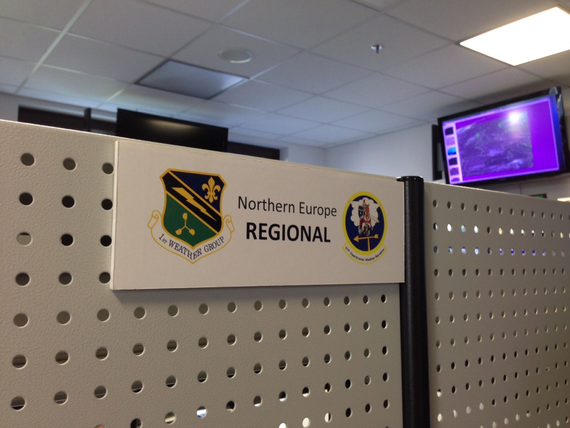 A sign is mounted by a duty position in the 21st Operational Weather Squadron April 8, 2015, at Vogelweh Military Complex, Germany.  Airmen from the 21st OWS provide watches, advisories and forecast for northern and southern Europe and Africa. (U.S. Air Force photo/Courtesy Photo)