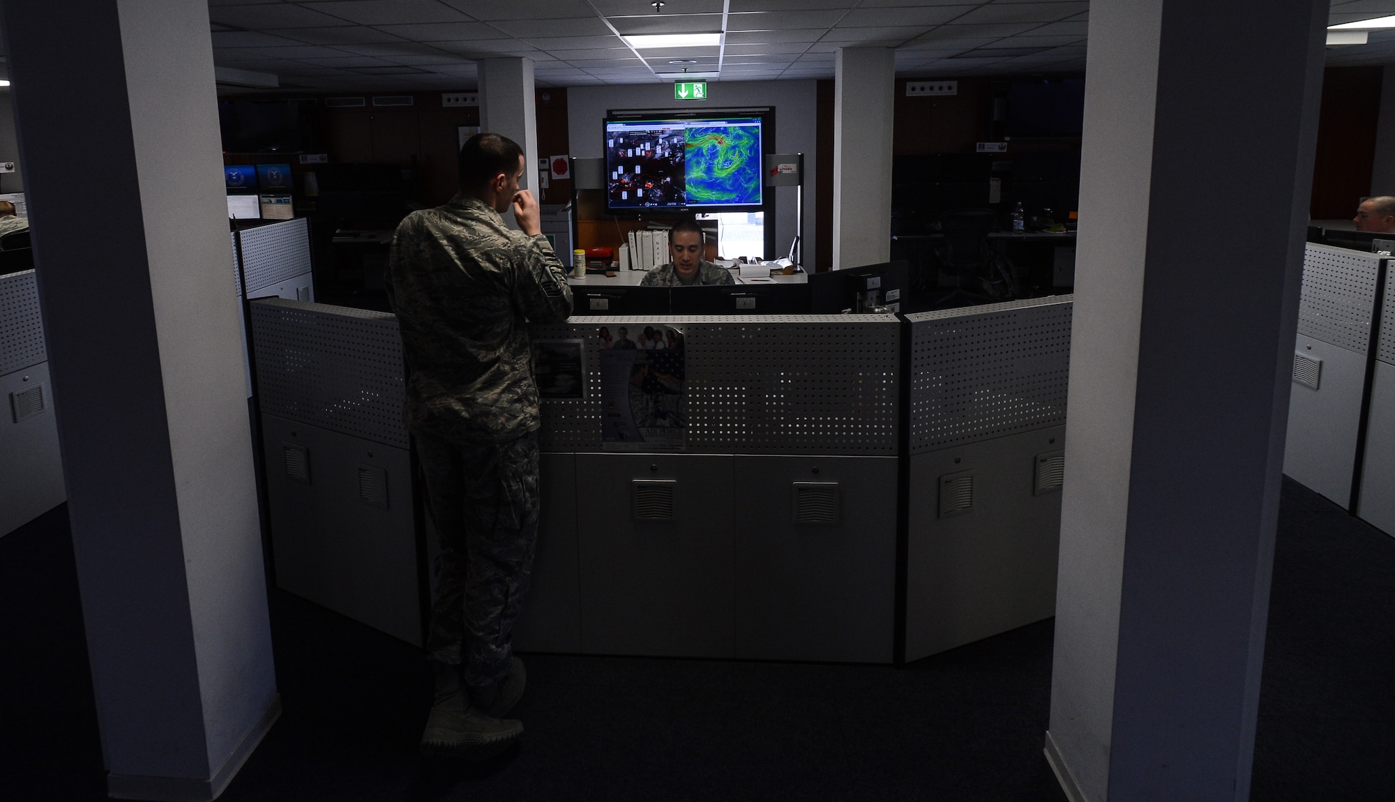 Airmen stand at the front desk of the 21st Operational Weather Squadron April 8, 2015, at Vogelweh Military Complex, Germany.  Airmen from the 21st OWS have been realigned from  U.S. Air Forces in Europe and Air Forces Africa to Air Combat Command but will still provide the same services to Europe and Africa. (U.S. Air Force photo/Senior Airman Nicole Sikorski)