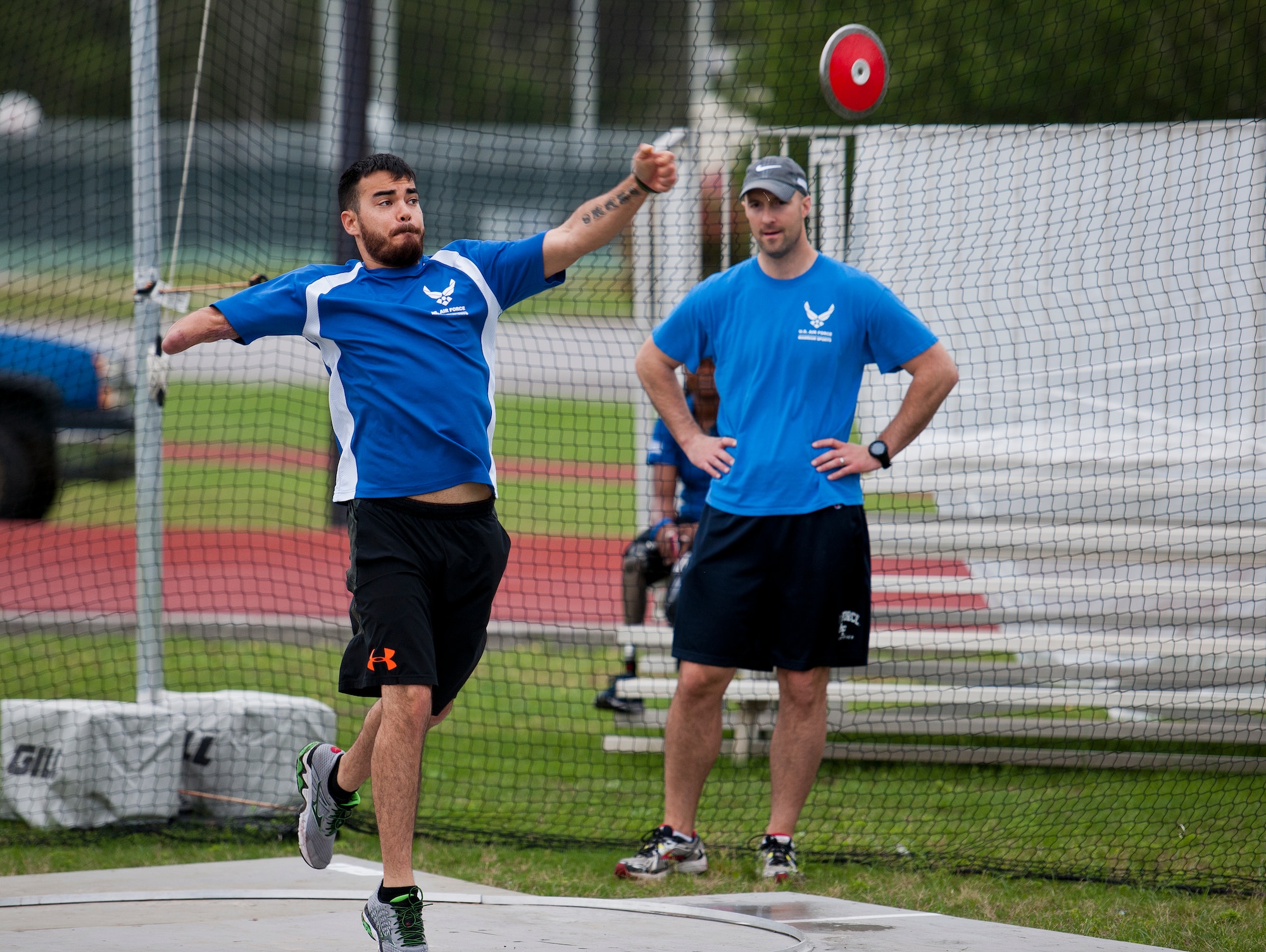 Daniel Crane, an Air Force Wounded Warrior mentor-athlete, releases the discus at a track and field session during the third day of the Warrior Games training camp at Eglin Air Force Base, Fla., April 20. Crane, who survived a shotgun injury, first participated in the military adaptive sports program in 2014.  He will compete in the archery and shooting events at the DoD Warrior Games June 19-28 at Marine Corps Base Quantico, Va.  (U.S. Air Force photo/Samuel King Jr.)