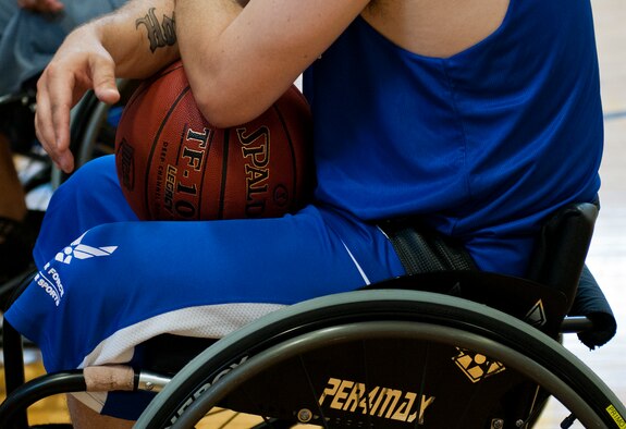 Tech. Sgt. Ryan Delaney, holds a basketball waiting for the next practice session begin during the third day of the Warrior Games training camp at Eglin Air Force Base, Fla., April 20. The five-day training camp for the Air Force’s athletes serves as their last practice session before the Warrior Games June 19-28. (U.S. Air Force photo/Samuel King Jr.)