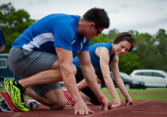 Timothy Babb and Lara Mastell,  Air Force Wounded Warrior athletes, get into the starting position at a track and field session during the third day of the Warrior Games training camp at Eglin Air Force Base, Fla., April 20. The five-day training camp for the Air Force’s athletes serves as their last practice session before the Warrior Games June 19-28. (U.S. Air Force photo/Samuel King Jr.)
