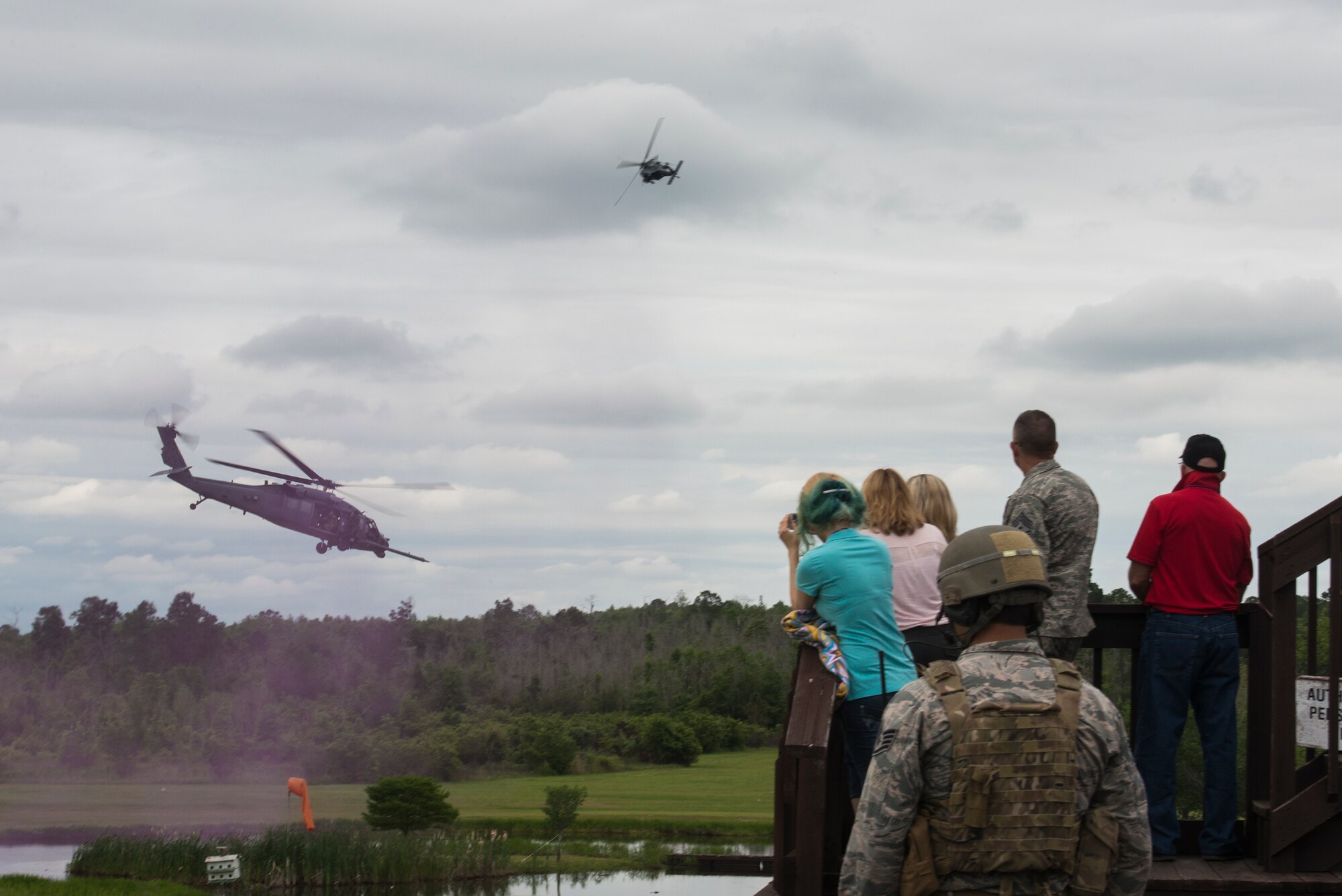HH-60G Pave Hawks from the 41st Rescue Squadron fly in front of spectators during a combat search and rescue demonstration April 17, 2015, at Moody Air Force Base, Ga. The CSAR demo was a part of a base tour for guests of the Red Carpet of South Georgia’s 50th Anniversary party. (U.S. Air Force photo by Senior Airman Ryan Callaghan/Released)
