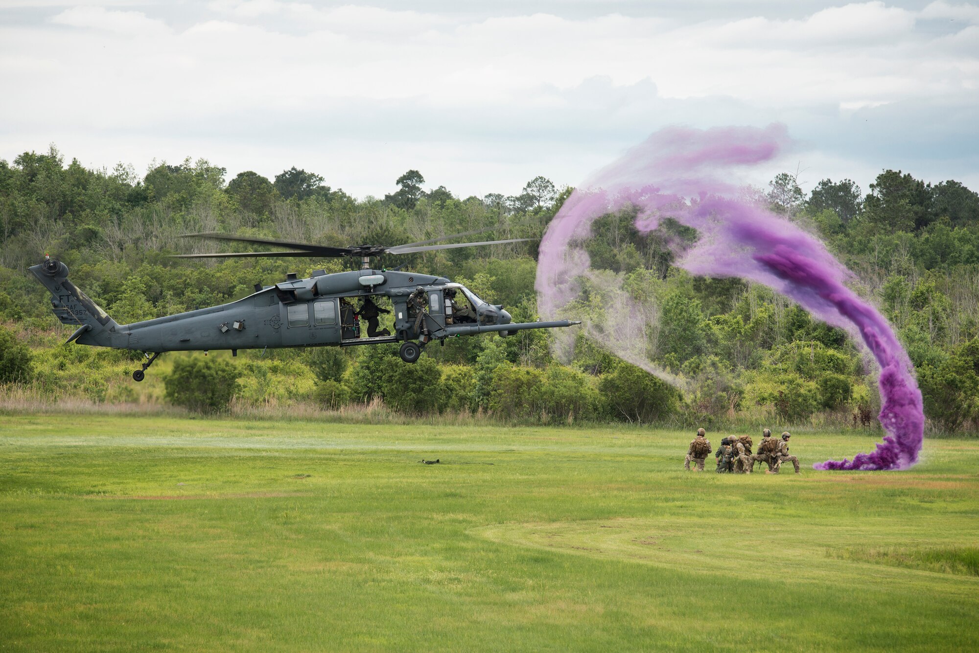 An HH-60G Pave Hawk from the 41st Rescue Squadron approaches a group of pararescuemen from the 38th RQS as a part of a combat search and rescue demonstration April 17, 2015, at Moody Air Force Base, Ga. The demonstration simulated the rescue of a downed pilot in the midst of enemy fire. (U.S. Air Force photo by Senior Airman Ryan Callaghan/Released)