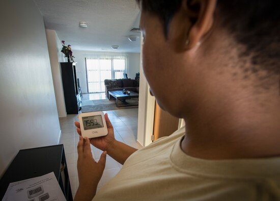 Tech. Sgt. Alexis Martin, 39th Logistics Readiness Squadron NCO in charge of deployments, checks the energy consumption on a new Residential Energy Efficiency Program wireless energy monitoring device April 13, 2015, at Incirlik Air Base, Turkey. This wireless energy monitor shows instant, history and the average of each housing unit’s energy consumption, along with cost and carbon-dioxide emissions. (U.S. Air Force photo by Airman 1st Class Cory W. Bush/Released)