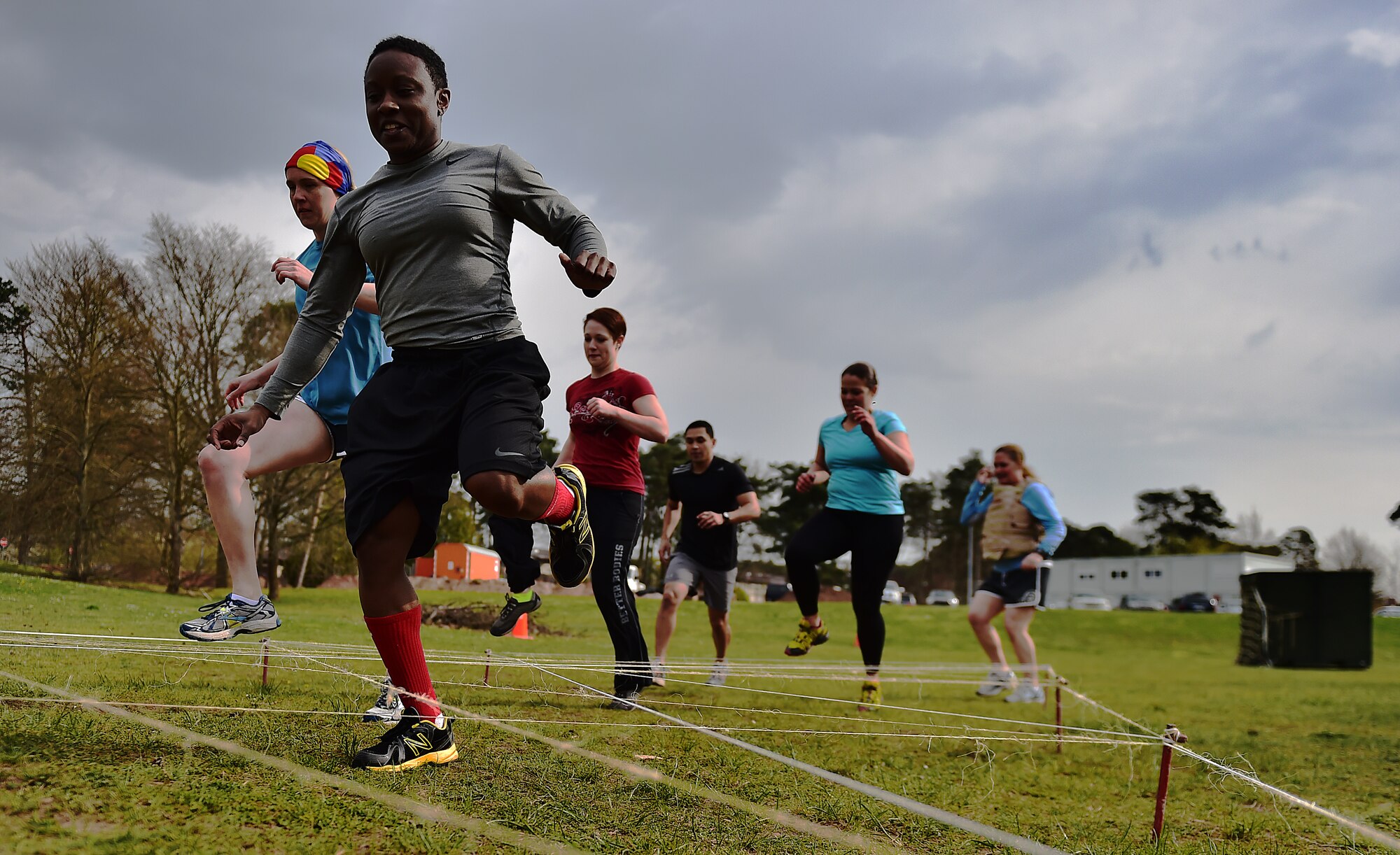 A six-man team from the 86th Medical Operations Squadron runs through the spider web obstacle during the Courage, Leadership, Education, Advocacy and Respect Challenge April 17, 2015, at Ramstein Air Base, Germany. The CLEAR Challenge was a physically and mentally challenging course symbolizing the effects of sexual assault and alcohol abuse. Teams competed to complete the tasks or obstacles for the best time. (U.S. Air Force photo/Staff Sgt. Sara Keller) 