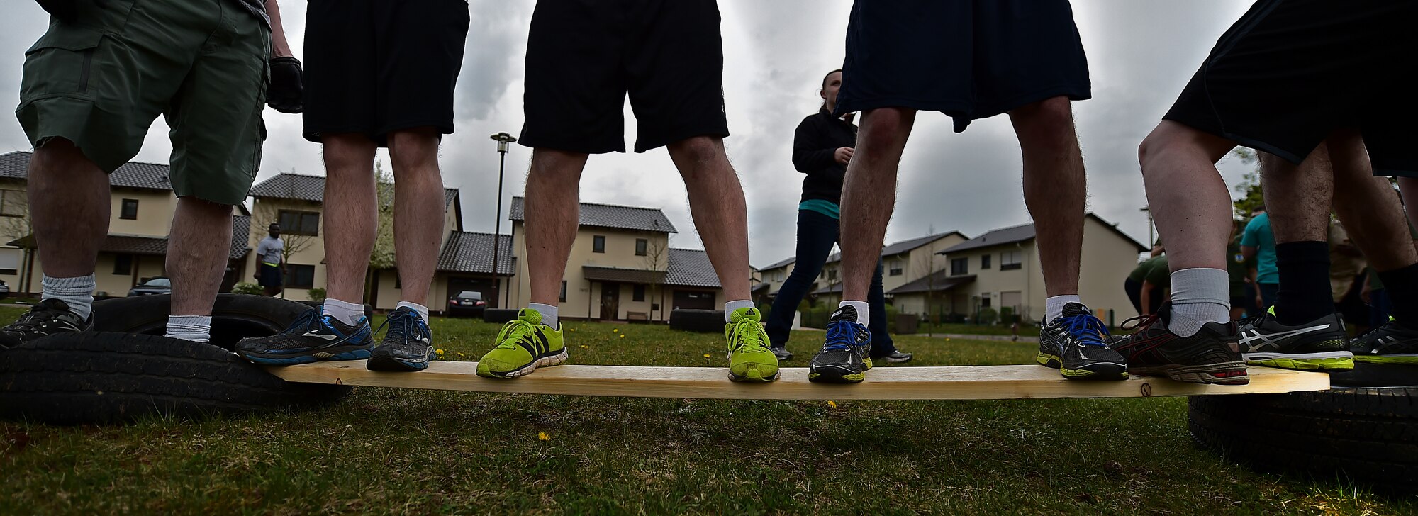 A team balances on a board as they attempt to complete the final obstacle during the Courage, Leadership, Education, Advocacy and Respect Challenge April 17, 2015, at Ramstein Air Base, Germany. The CLEAR Challenge was a physically and mentally challenging course symbolizing the effects of sexual assault and alcohol abuse. Teams competed to complete the tasks or obstacles for the best time. (U.S. Air Force photo/Staff Sgt. Sara Keller)