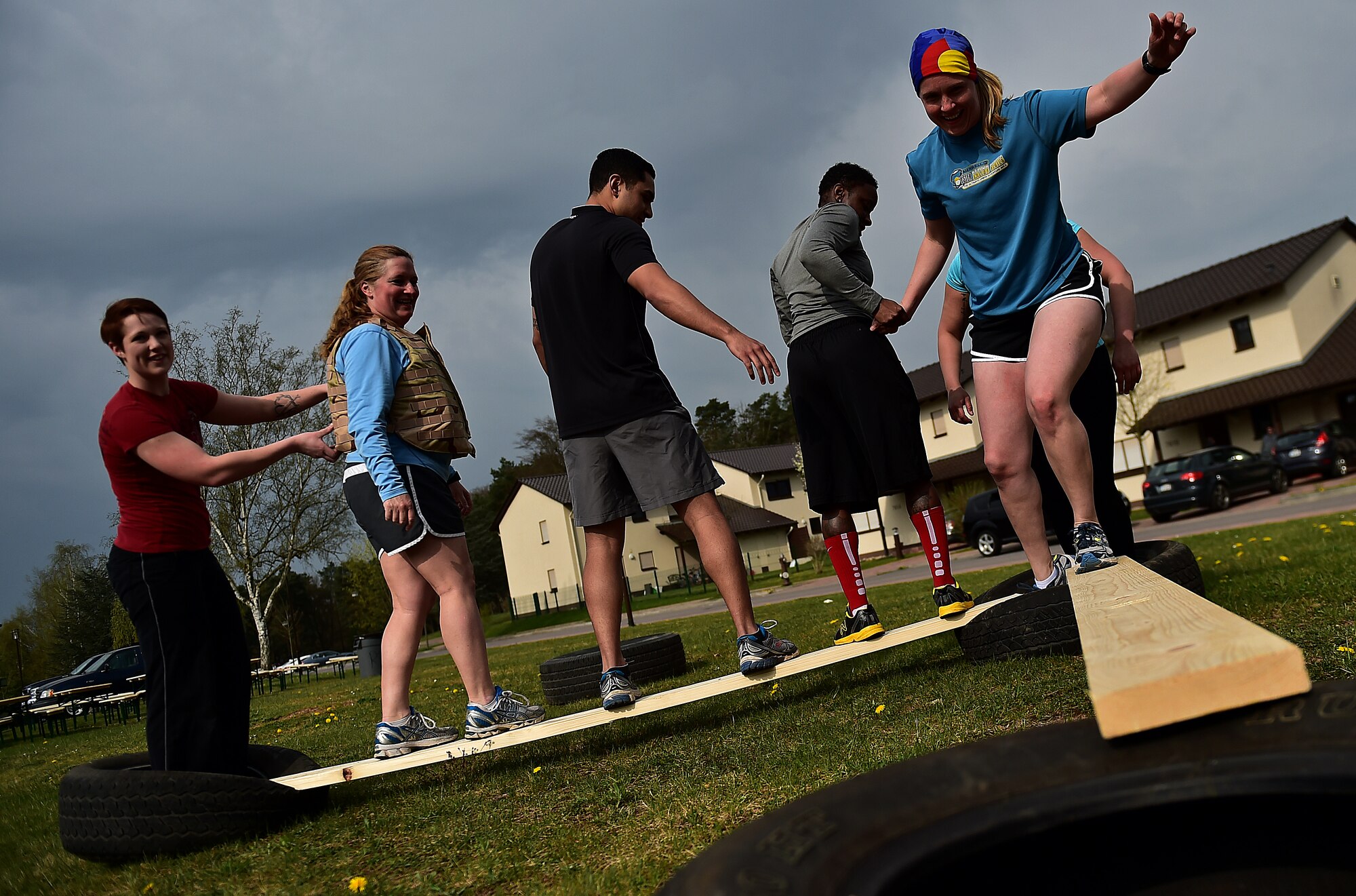 A six-man team from the 86th Medical Operations Squadron work together to complete the last obstacle during the Courage, Leadership, Education, Advocacy and Respect Challenge April 17, 2015, at Ramstein Air Base, Germany. The CLEAR Challenge participants went through many obstacles, representing challenges a sexual assault victim may face, to encourage teamwork and taking care of each other. (U.S. Air Force photo/Staff Sgt. Sara Keller)