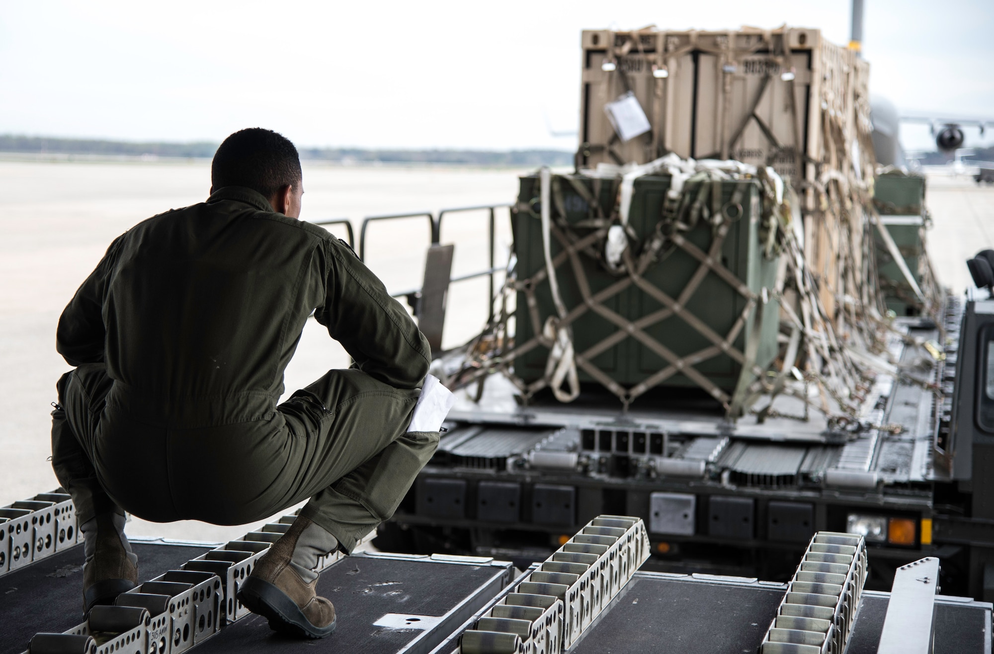 Senior Airman Tom Chamberlain III, 6th Airlift Squadron loadmaster, guides a Tunner 60K loader to the back of a C-17 Globemaster III at Joint Base Andrews, Md., April 15, 2015. Loadmasters and aircraft specialists work together to ensure accountability, safety and efficient load times. (U.S. Air Force photo/Airman 1st Class Philip Bryant)