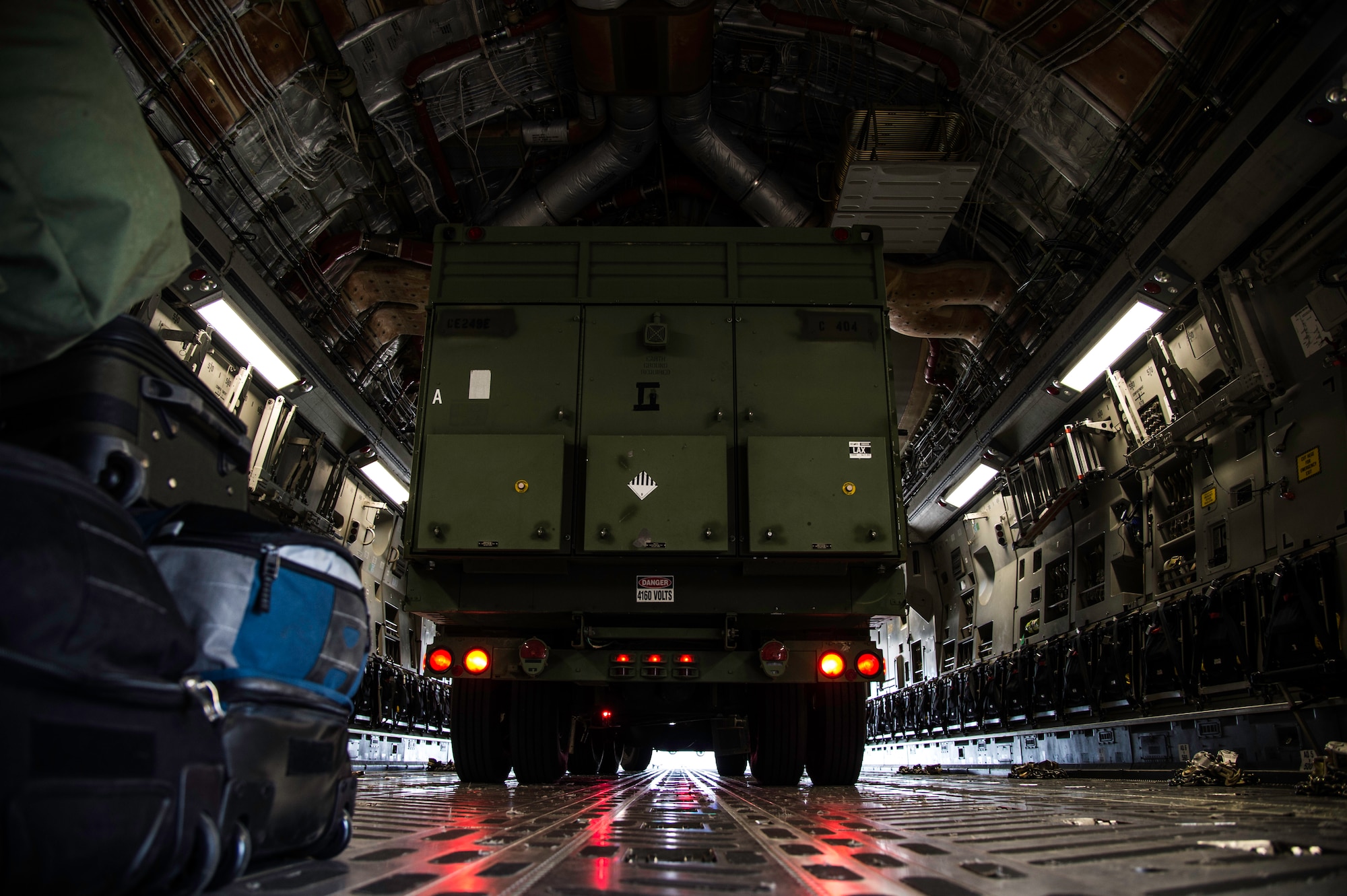 A U.S. Army truck backs into a C-17 Globemaster III at Joint Base Andrews, Md., April 15, 2015. The 89th Aerial Port Squadron works to facilitate joint-military airlift operations at JBA. (U.S. Air Force photo/Airman 1st Class Philip Bryant)