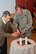 U.S. Air Force Col. Kenneth T. Bibb Jr., right, 100th Air Refueling Wing commander, and Rudy Oppenheimer, a Holocaust survivor, light candles to remember those who lost their lives during the Holocaust and those who are survivors, at a Holocaust Remembrance Week luncheon April 16, 2015, on RAF Mildenhall, England. Oppenheimer, 83, was guest speaker at the luncheon. Born in Germany, he moved to the Netherlands when he was 4 years old. His family was Jewish, but because his sister was born in England, they were sent to an exchange camp where they were treated less harshly than others. Once the camps were liberated in 1945, the family moved to England to live with Oppenheimer’s uncle. (U.S. Air Force photo by Karen Abeyasekere/Released)