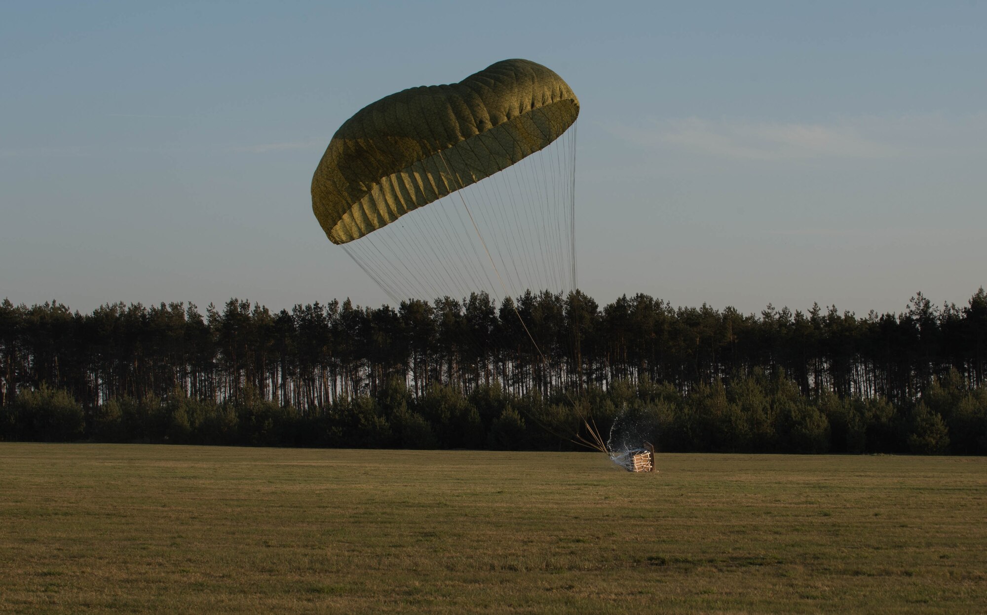 A container delivery system lands at Powidz Air Base, Poland, April 15, 2015. The 37th Airlift Squadron had the honor of air dropping the bundle which was a first at Powidz. Approximately 130 service members from throughout Europe along with Airmen from the 302nd Airlift Wing arrived to Powidz to train alongside their Polish counterparts as part of an aviation detachment rotation. (U.S. Air Force photo/Senior Airman Jonathan Stefanko)
