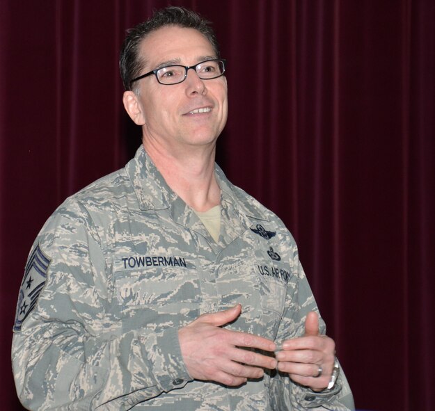 U.S. Air Force Chief Master Sgt. Roger Towberman, 25th AF command chief, speaks with Team Mildenhall members during a town hall meeting April 20, 2015, on RAF Mildenhall, England. Towberman spoke with Airmen during a question-and-answer session about the importance of being mission-focused. (U.S. Air Force photo by Gina Randall/Released)