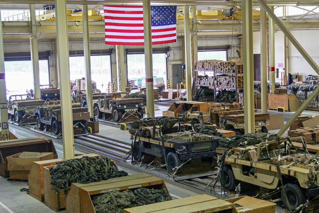 Vehicles and equipment await delivery at the heavy drop rigging facility on Pope Army Airfield, N.C., April 13, 2015. The equipment supports Combined Joint Operational Access Exercise 15-01, led by the 82nd Airborne Division's 2nd Brigade Combat Team. It's the largest bilateral exercise on Fort Bragg in almost 20 years.