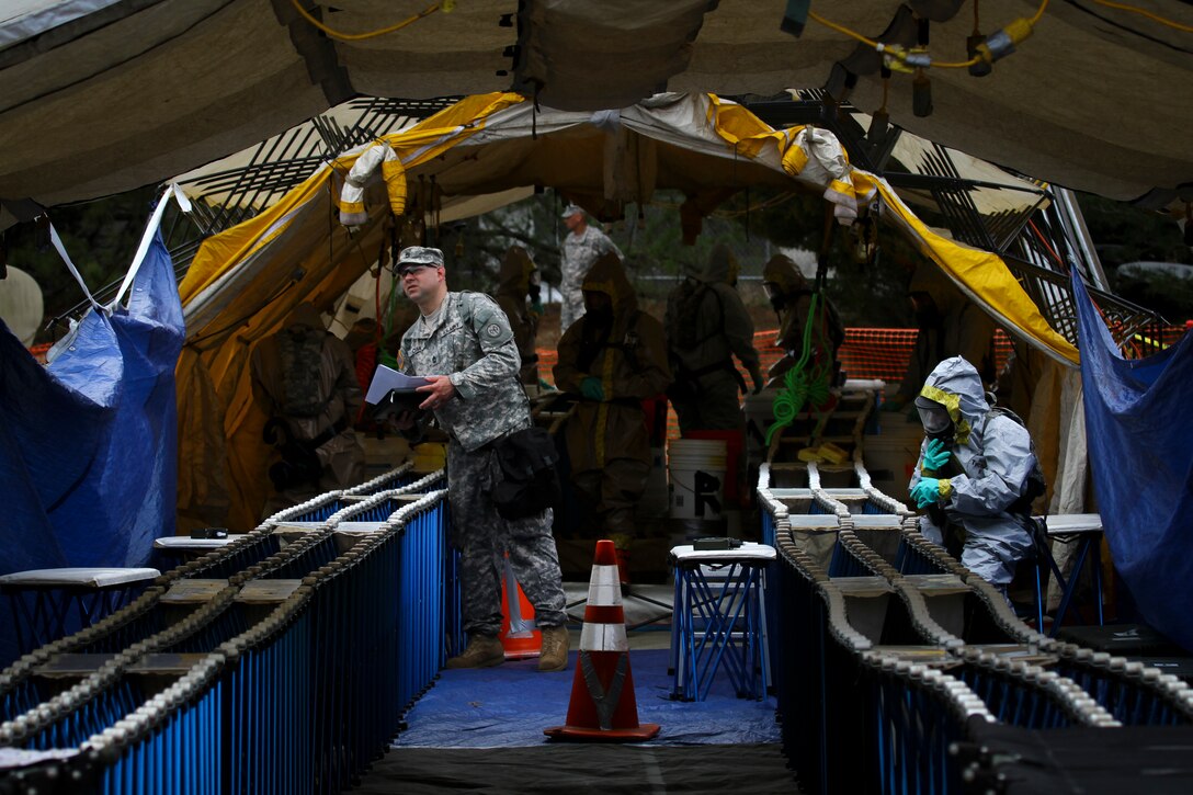 Army soldiers stand by to decontaminate victims during a full-scale ...