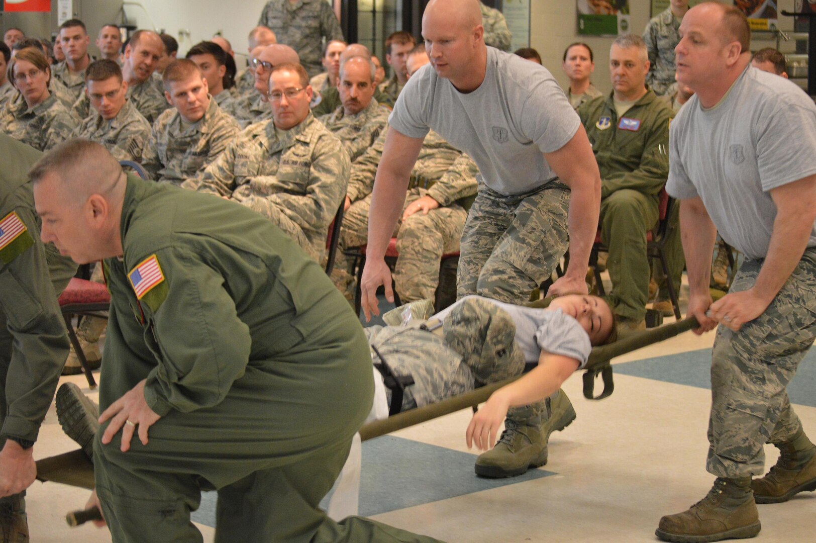 Volunteers demonstrate self-aid buddy care in a combat situation during a briefing as part of the 109th Airlift Wing's first ancillary training rodeo April 18, 2015. More than 200 Airmen went through the training which also included hands-on SABC as well as hands-on chemical, biological, radiological and nuclear training.